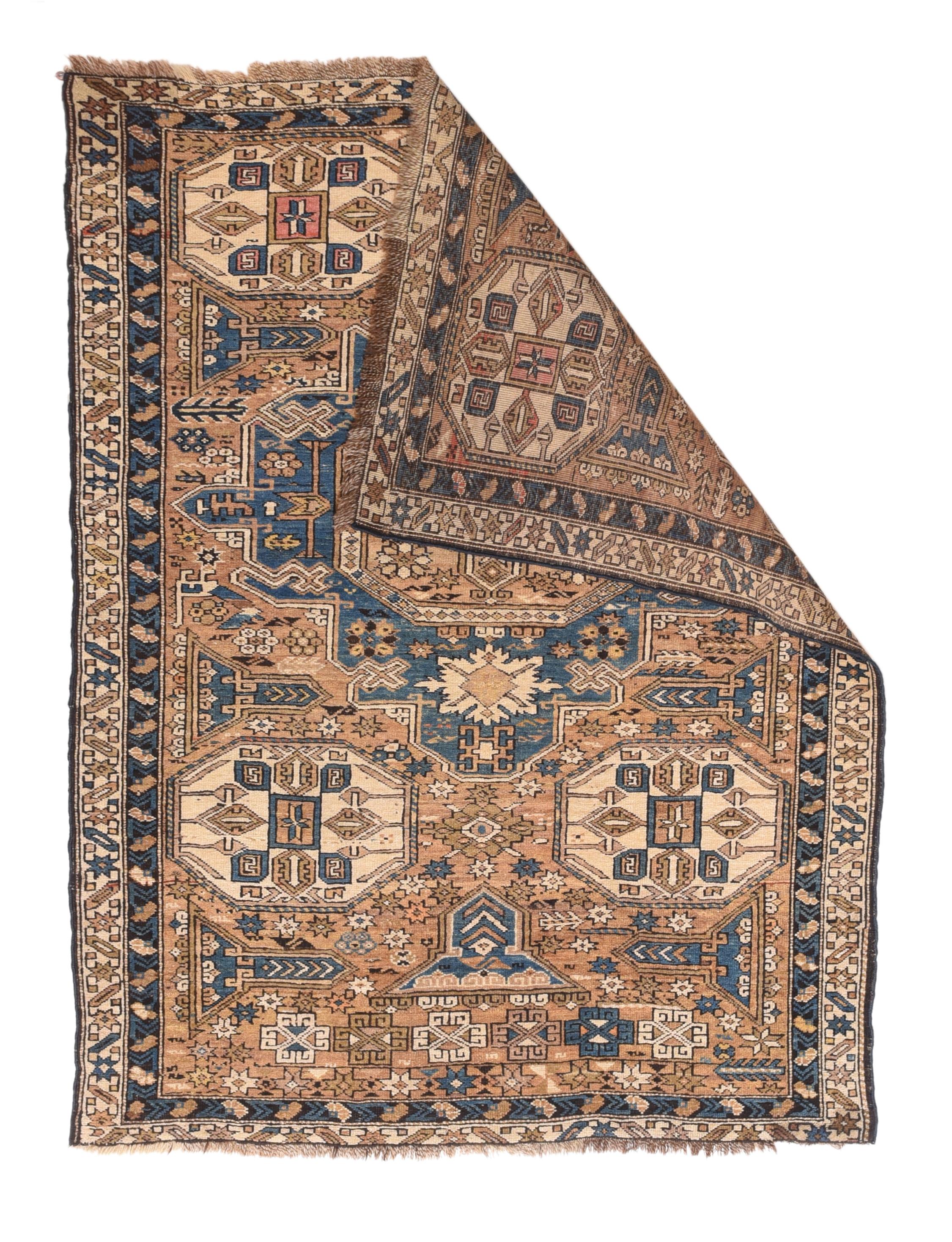 Adapted from a flatwoven Soumak rug design, this east Caucasian scatter shows a single reticulated medium blue faceted cruciform medallion with four pale straw secondary octagons and lateral; “rocket ships” on a dusty rose field. A row of squared