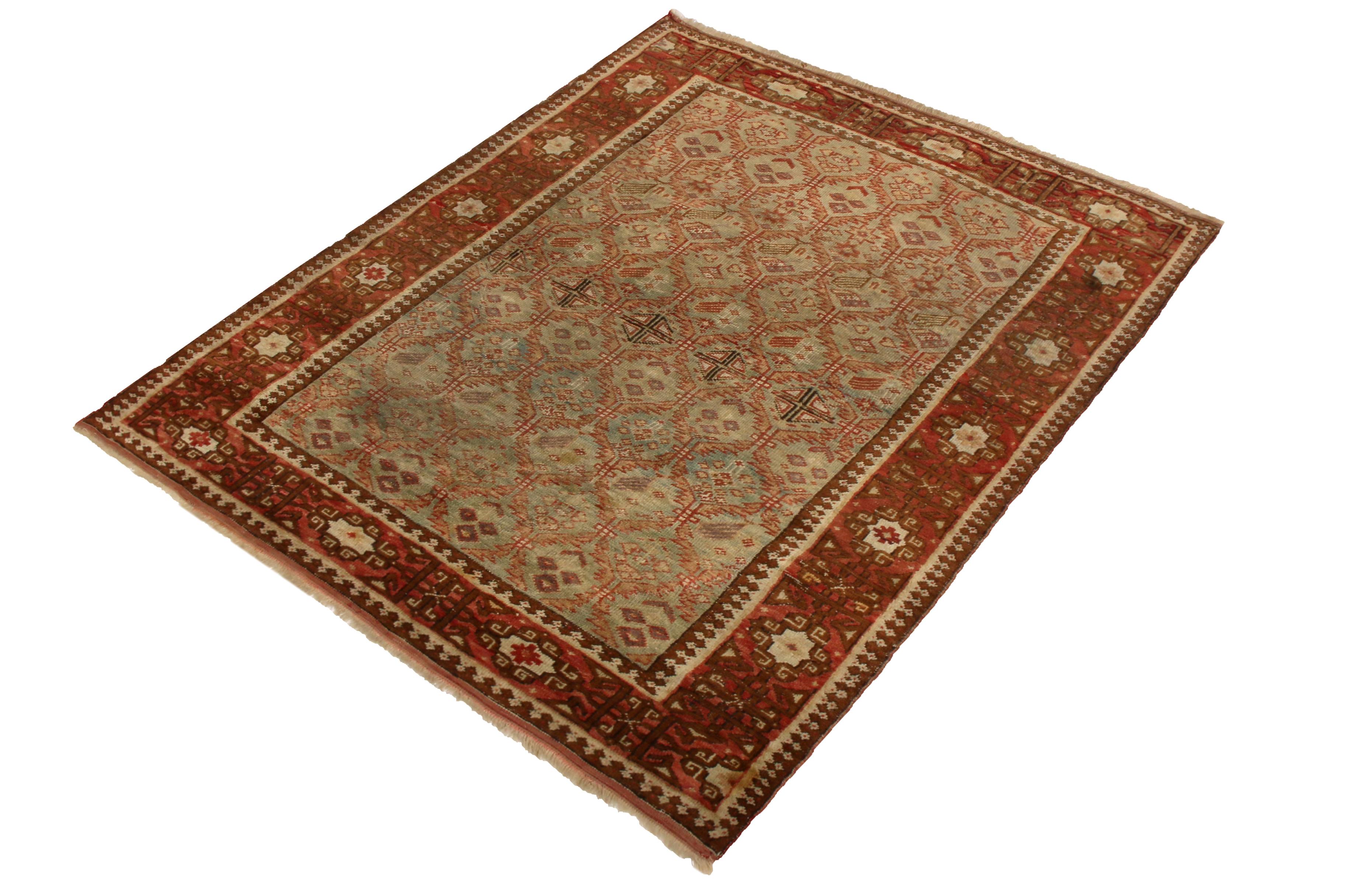 Hand knotted in wool originating from Russia between 1890-1900, this antique Shirvan rug enjoys an uncommon green background with notes of blue in the field, a rare but natural complement to the classic beige-brown and rich, burnt red traditional
