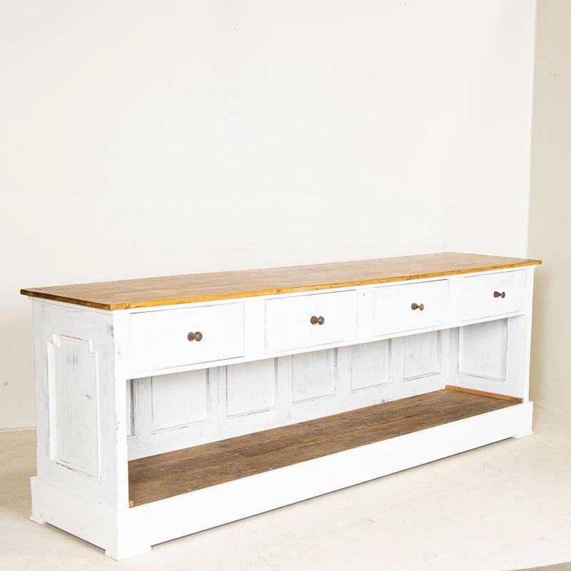 This antique pine shop counter is a great find due to its length; at 8.5 long, it can be used as a serving buffet, urban farmhouse kitchen island (it is free-standing, painted white on the back) or even as a double sink in a large bathroom. The 4
