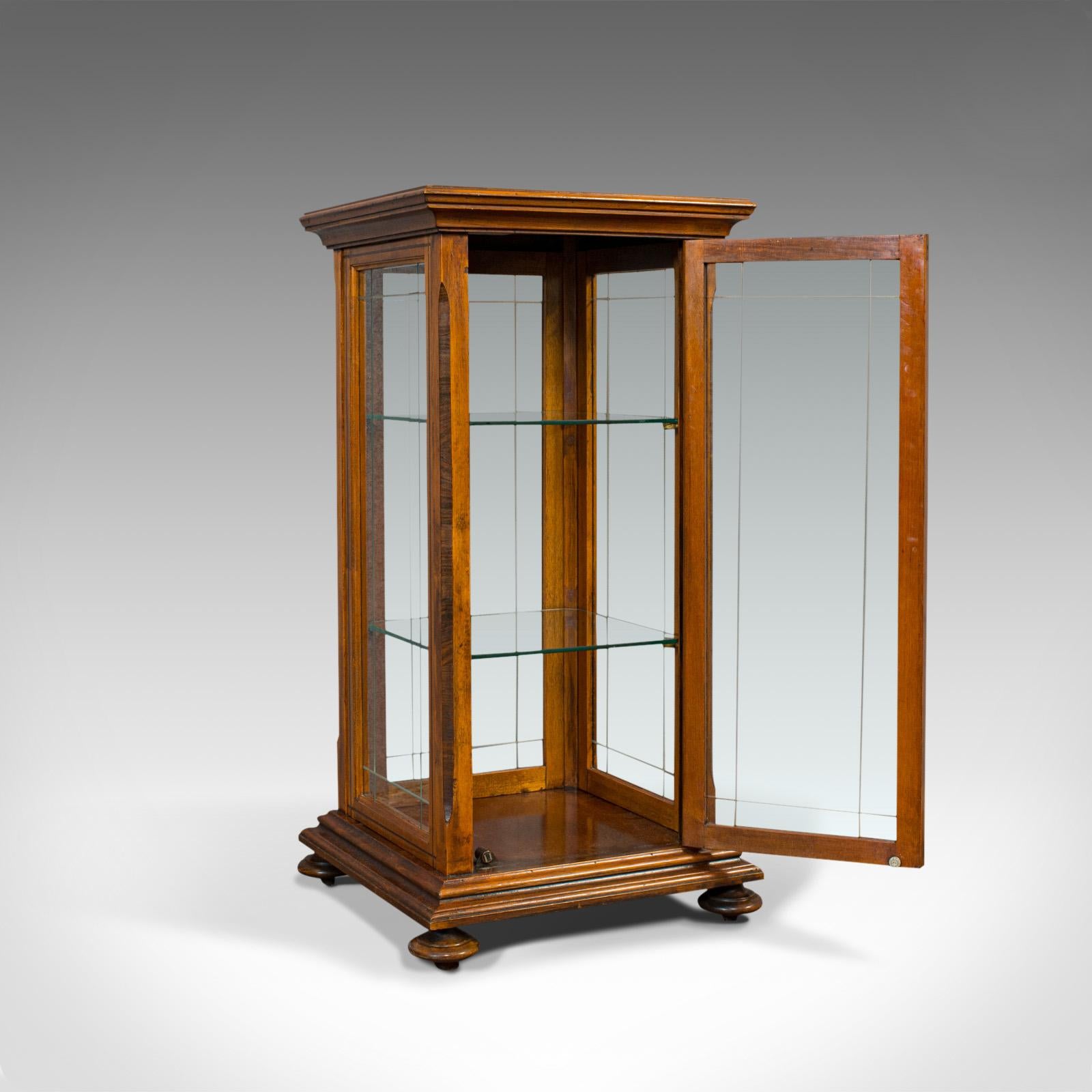 This is an antique shop display cabinet. An English, oak and walnut showcase, dating to the Edwardian period, circa 1910.

Beautifully glazed cabinet
Displays a desirable aged patina
Oak shows fine grain interest and pleasing caramel