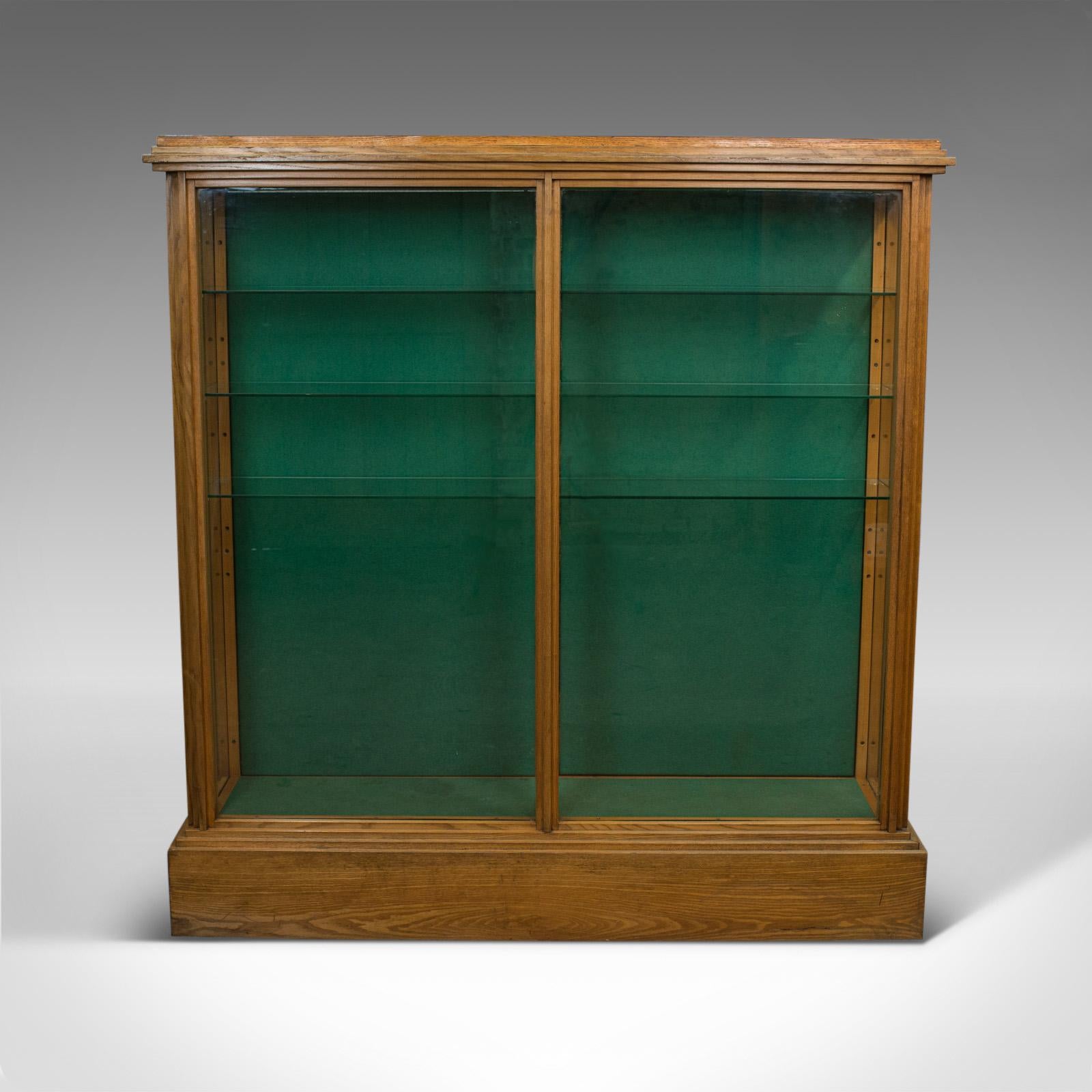 This is an antique shop display cabinet. An English, Victorian ash show case shop fitting dating to the late 19th century, circa 1900.

Select ash gives an air of commercial purpose, typical of Victorian stores
Showing wonderful biscuits hues