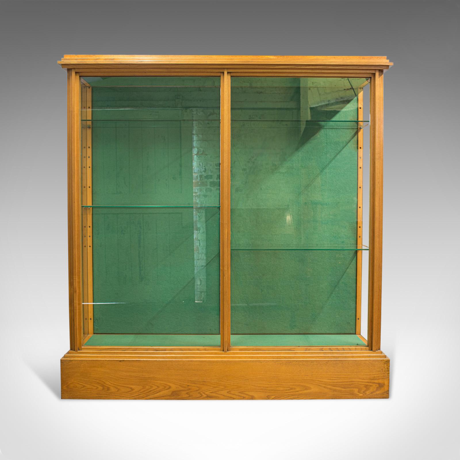 This is an antique shop display cabinet. An English, Victorian ash showcase shop fitting dating to the late 19th century, circa 1900.

Select ash gives an air of commercial purpose, typical of Victorian stores
Showing wonderful biscuits hues with