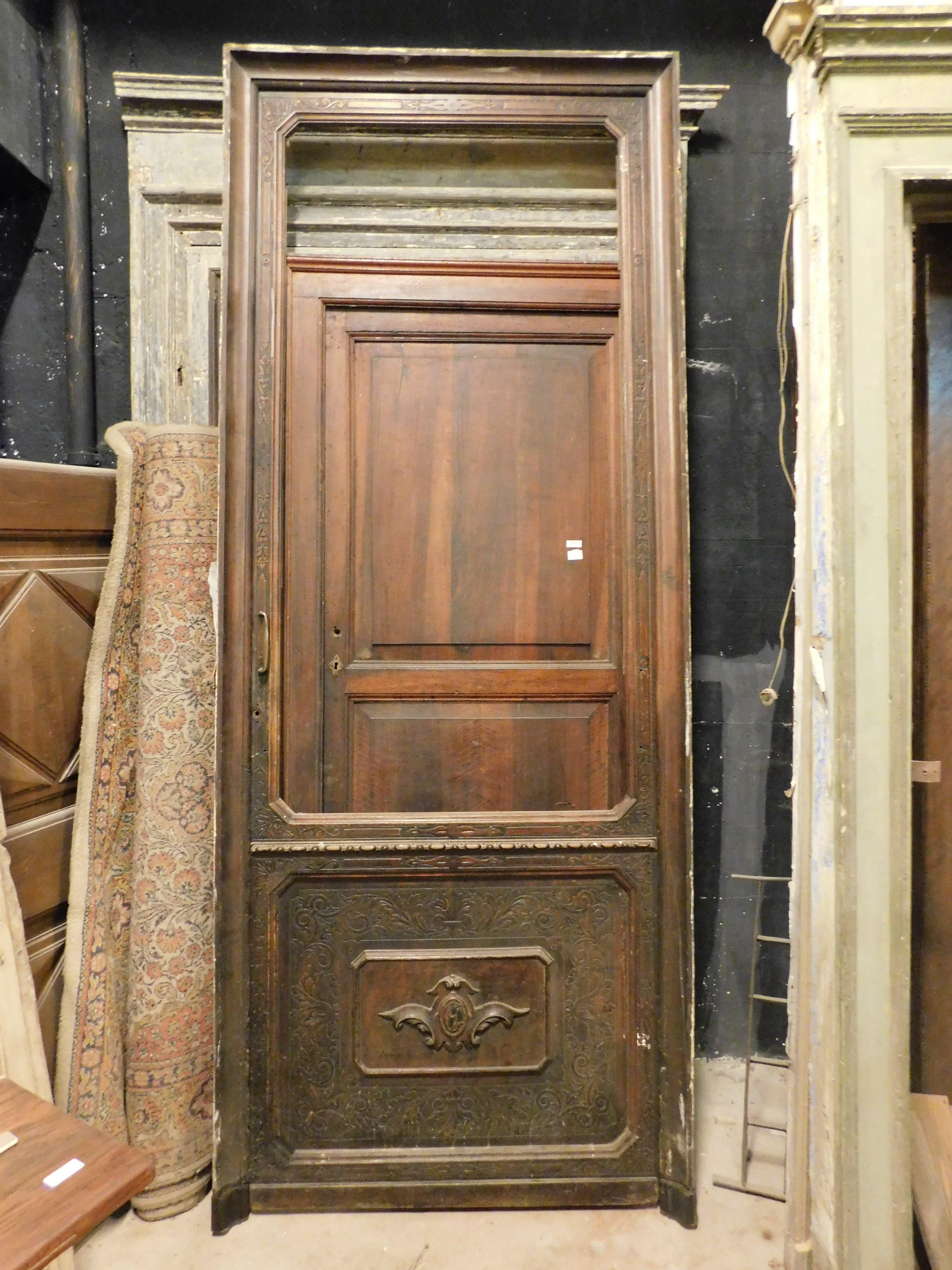 Ancient walnut shop door, historic shop front with carved panel, complete with frame and ironwork, to be reglazed and lock fixed, built in the 1800s for a venue in the historic center of Italy.
Ideal as a dividing door in environments that require