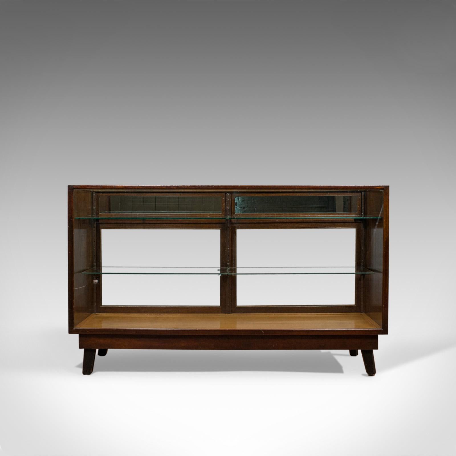This is an antique commercial display cabinet. An English, mahogany and oak showcase dating to the Edwardian period, circa 1910.

Displays a desirable aged patina
Select cuts of mahogany and oak with fine grain interest
Original plate glass in