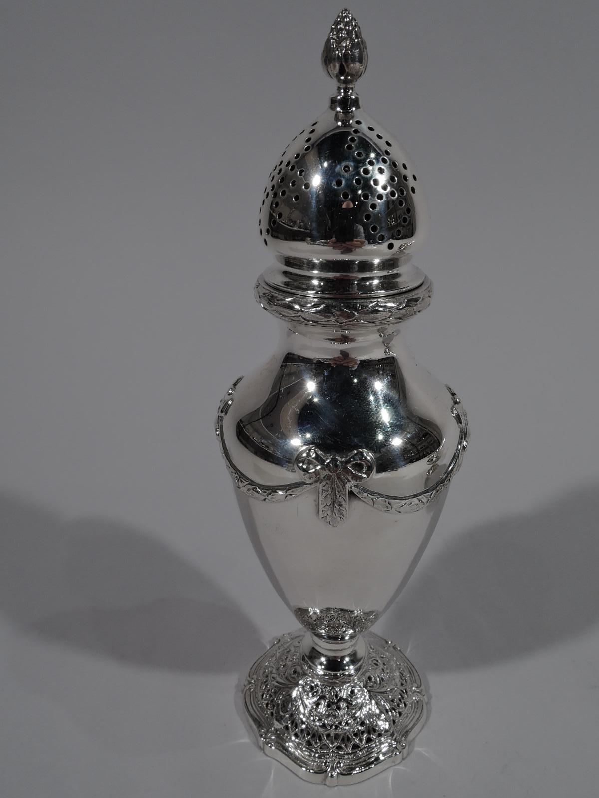 Edwardian Regency sterling silver salt and pepper. Made by Shreve & Co. in San Francisco, circa 1915. Salt is open bellied bowl. Pepper is baluster Shaker; cover pieced and domed with berry finial. Each has applied classical vases on open rondels