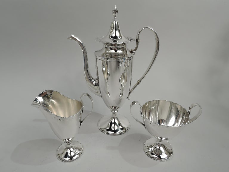 Modern Georgian sterling silver coffee set. Made by Shreve & Co. in San Francisco, ca 1910. This set comprises coffeepot, creamer, and sugar on tray. Coffeepot, creamer, and sugar have ovoid bodies. Handles high-looping and feet domed. Coffeepot has