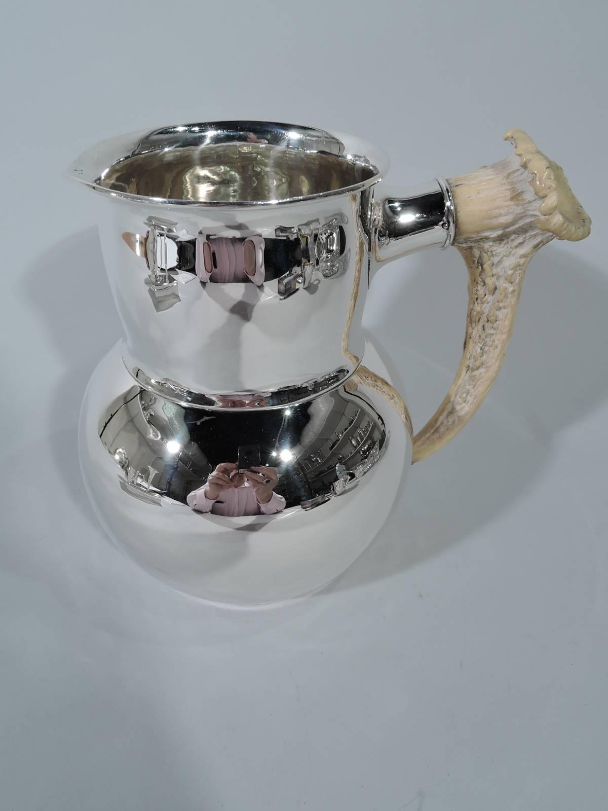 Edwardian sterling silver water pitcher with horn handle. Made by Shreve & Co. in San Francisco. Globular with drum-form neck, discreet lip spout, and silver mounts inset with tactile and irregular antler handle. Big game aesthetic. Hallmark