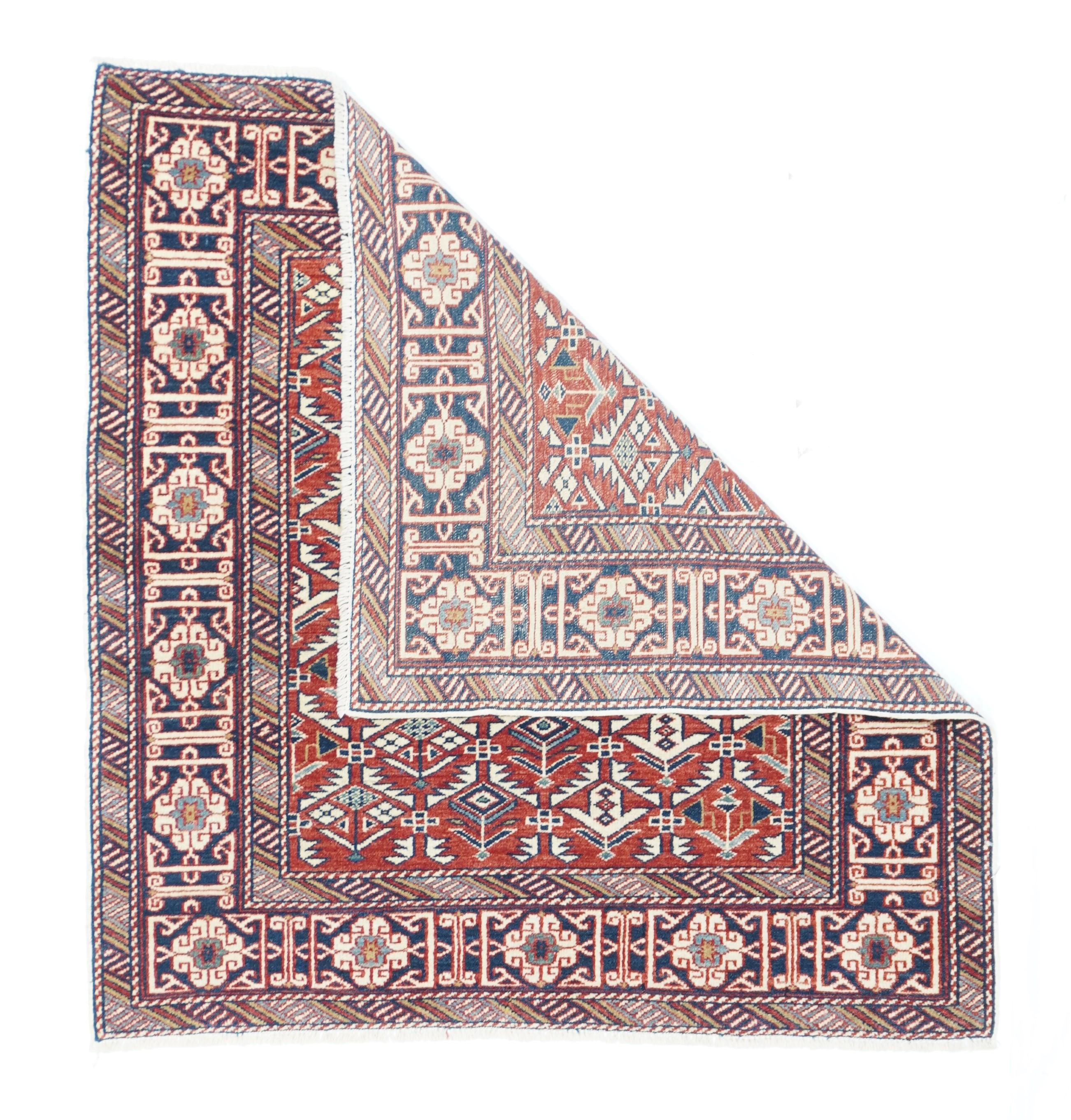 The madder red field displays an ivory serrated leaf hexagonal lattice with enclosed flowers, generally in the Shirvan-Daghestan style. A Kufesque knot and bracket border in brown-black is flanked by minors both with diagonally striped segment