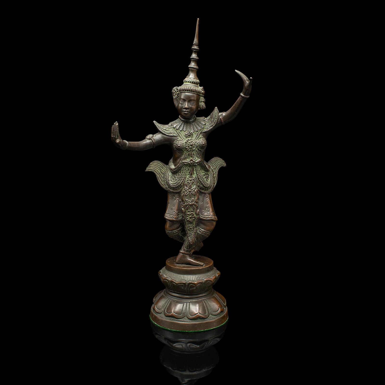 This is an antique Siamese dancer statue. A Thai, bronze deity figure, dating to the Victorian period, circa 1850.

Generously sized figure with superb detail to the outfit             
Displays a desirable aged patina and in good original