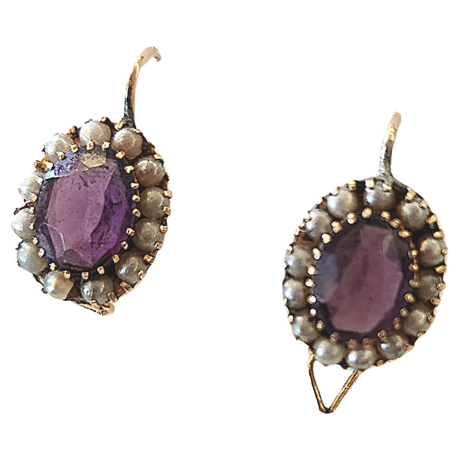 Antique imperial russian era 14k gold earrings centered with 2 oval cyberian amethyst stones flanked with natural white seed pearls earrings are hall marked with imperial russian gold standard and initial maker mark in cyrtlic alphabet