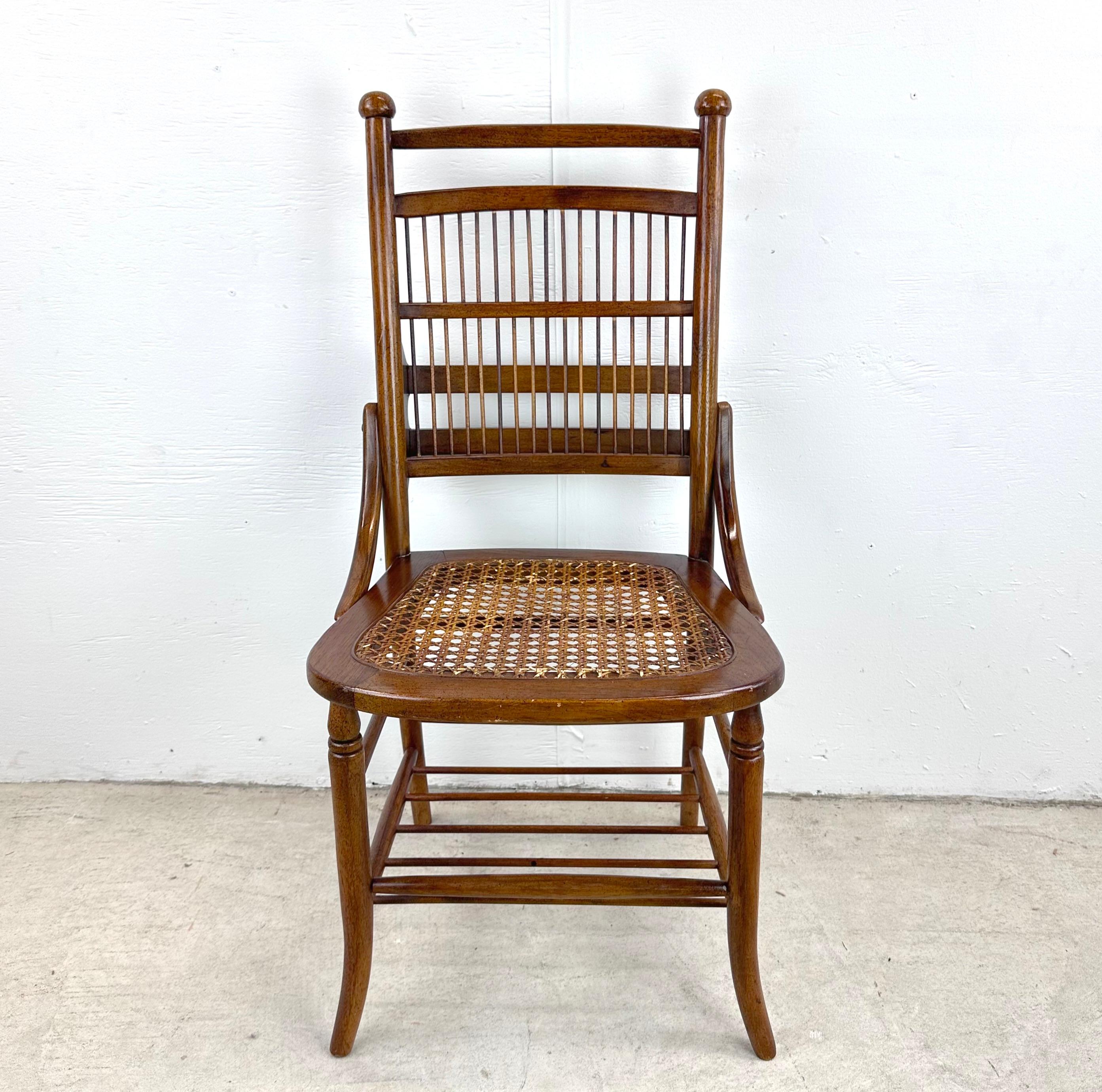 Are you in search of a unique piece of furniture that effortlessly combines history, craftsmanship, and aesthetic charm? Look no further than this Vintage Spindle Back Cane Seat Chair. This beautifully carved chair is a true testament to timeless