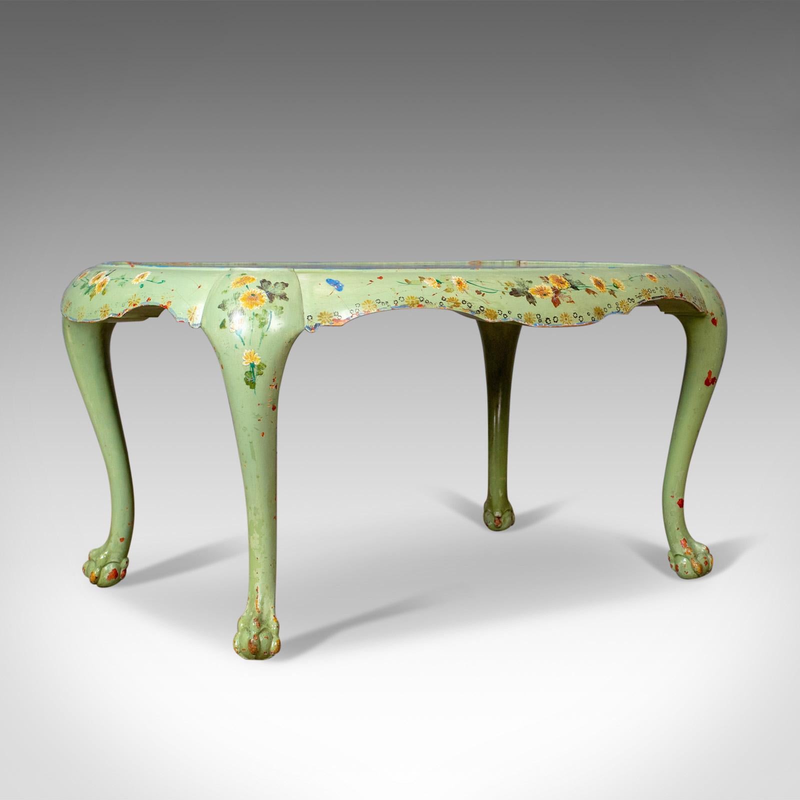 This is an antique side table, a French, country, hand painted coffee table dating to the early 20th century circa 1910.

Attractive, hand-painted French side table
Decorated with flowers, foliage and butterflies on a pale green ground
Ovular