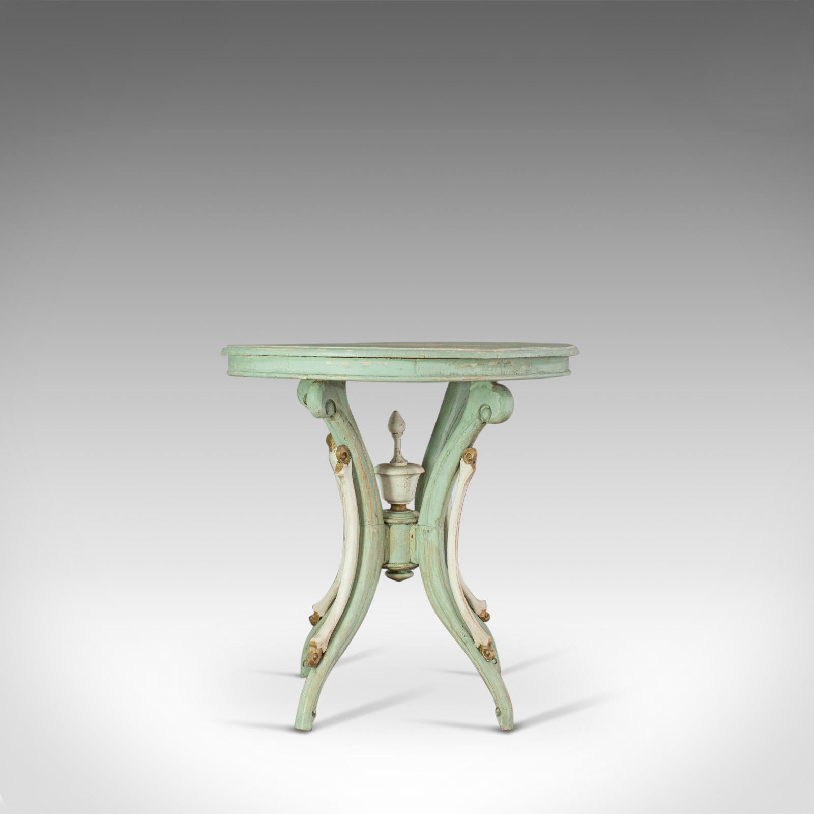 This is an antique side table. A French, painted pine cafe, lamp or occasional table dating to the late 19th century, circa 1890.

Desirable distressed finish, painted in pastels of mint and country white
Lifted with subtle highlights in gold and