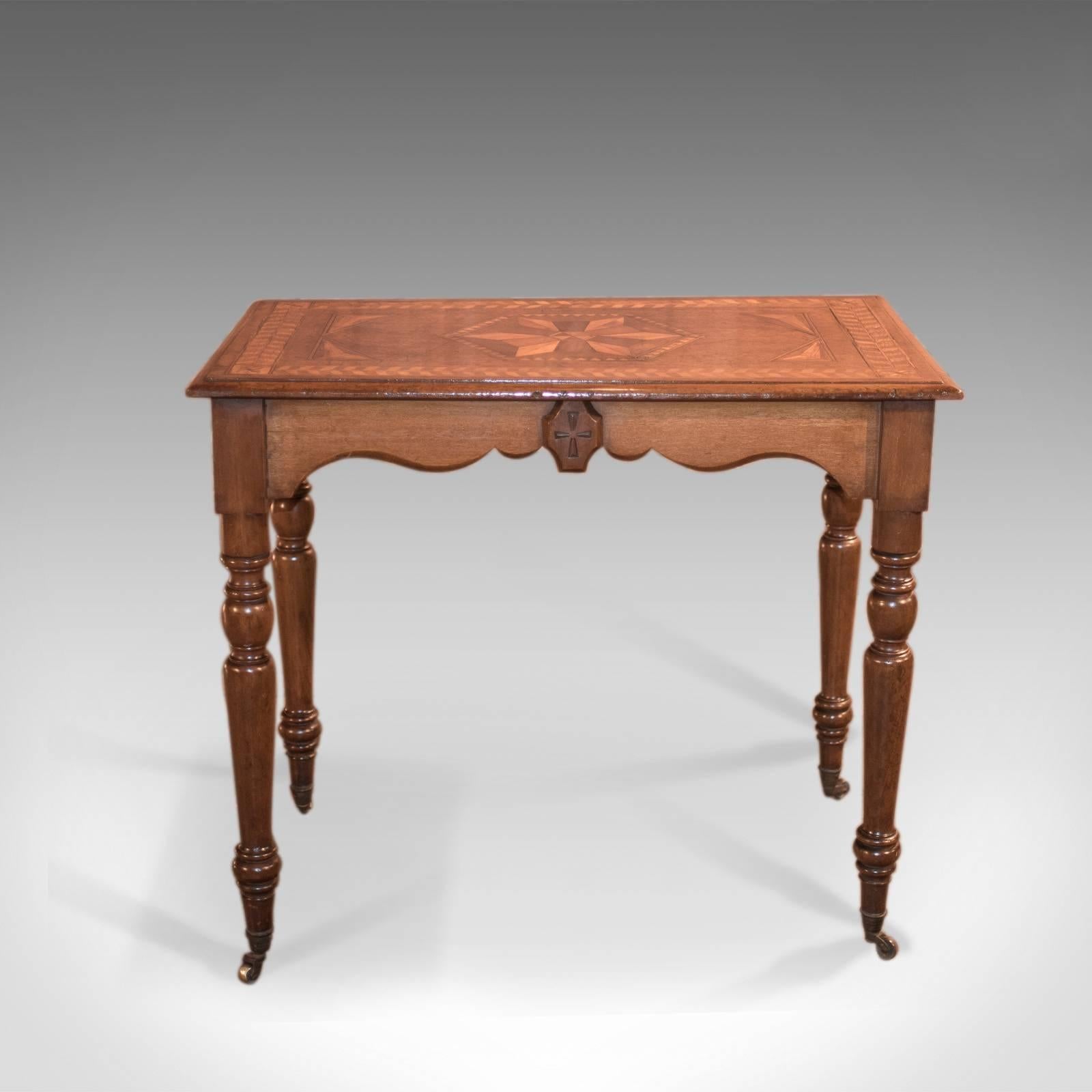 This is an attractive, antique side table dating to the late Georgian period circa 1800.

Light oak with honey tones
Desirable hues and an aged patina
Geometric inlay of oak, birch and mahogany
Ecclesiastical overtones
Serpentine chamfered