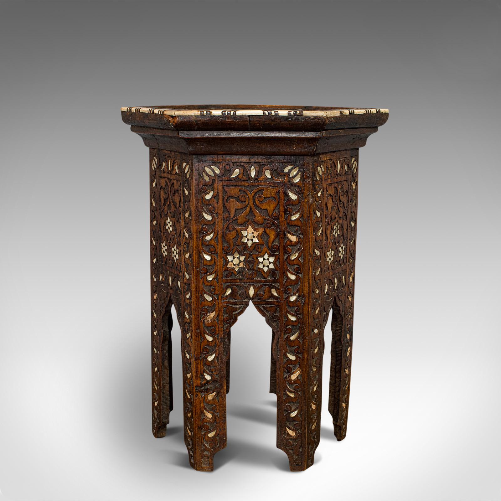 This is an antique side table. A Middle Eastern mahogany, Moorish-influenced hexagonal wine or occasional table, dating to the Victorian period, circa 1880.

Exotic taste with fascinating details
Displays a desirable aged patina
Carved mahogany