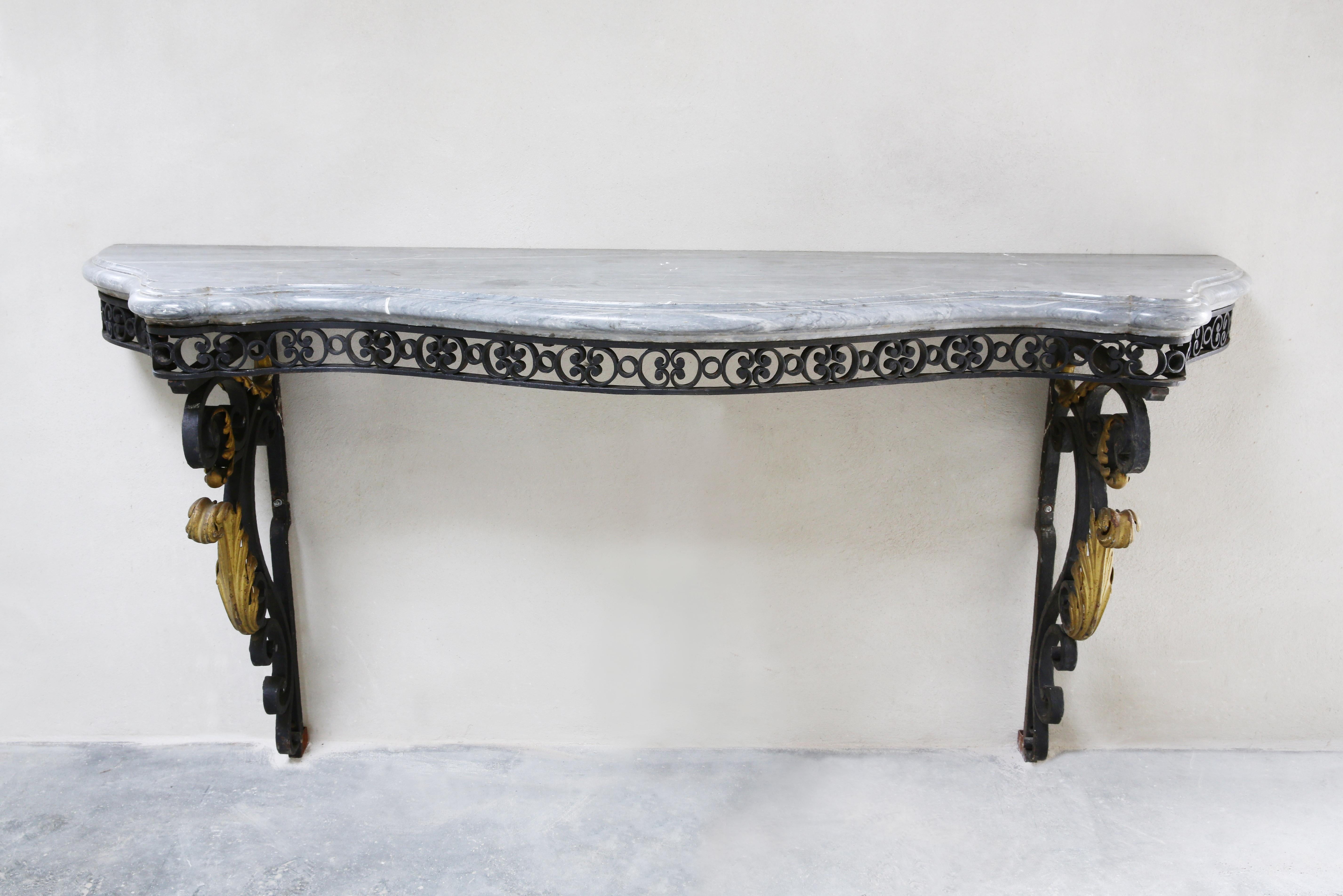 Beautiful exclusive antique side table from the 19th century in Baroque style. The base is beautifully decorated with gilded gold and black iron. The top consists of Turquin marble! A chic combination.