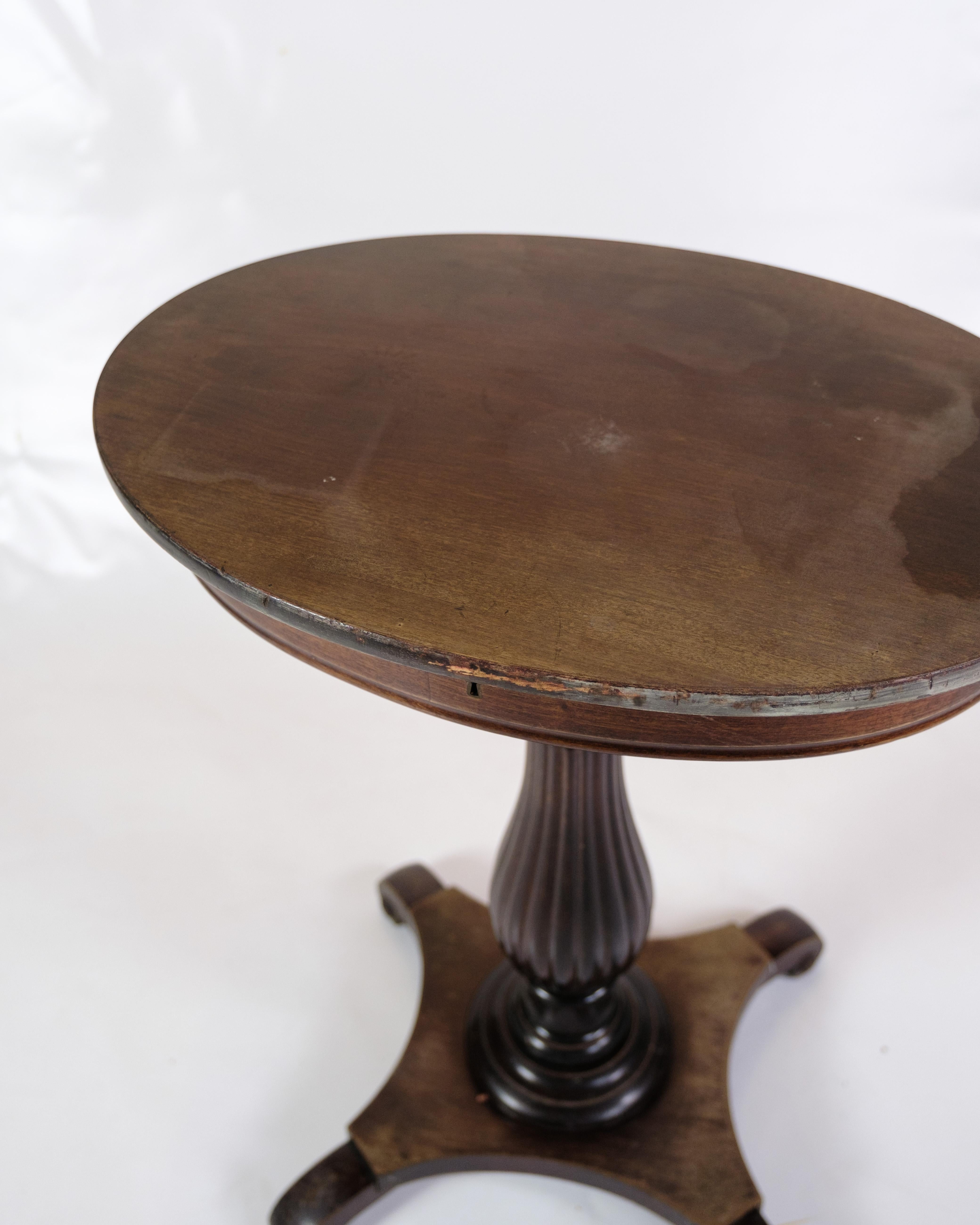 This elegant side table is a beautiful example of furniture craftsmanship from the 19th century, specifically the year 1890. Crafted from mahogany, this oval side table exudes timeless beauty and a warm, natural glow.

The most notable feature of