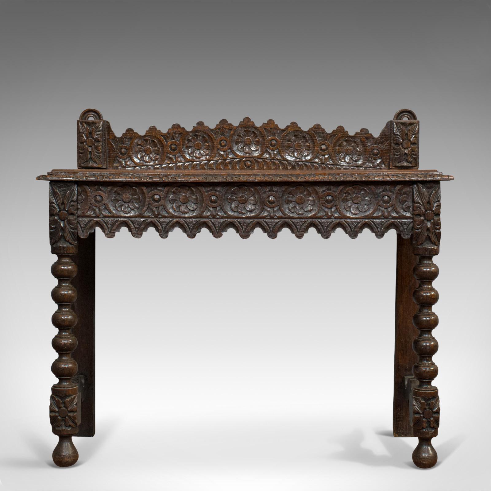 This is an antique side table. A Scottish, oak console table with bobbin turned legs, dating to the Victorian period, circa 1870.

Gothic revival taste with wonderful carved decoration
Displays a desirable aged patina
Select oak resplendent in