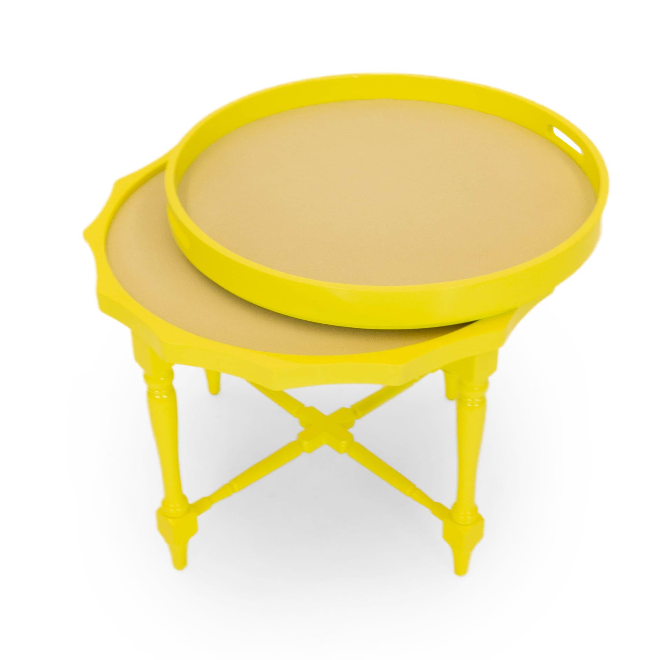 This round antique side table is newly lacquered in yellow. The table features a removable tray and turned legs as well as a textured vinyl inlay. A great accent piece for any room, this dual purpose table is functional and versatile.