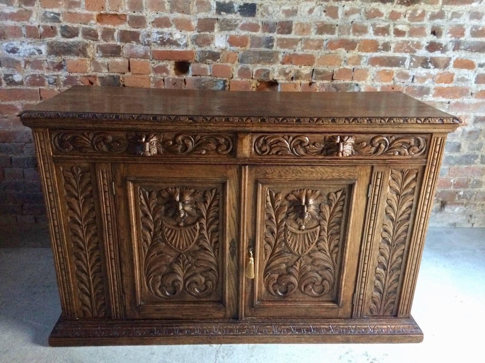 Antique 19th century 'Green Man' solid oak sideboard credenza in the Flemish manner, circa 1870, the rectangular over two crieze drawers over two cupboards with single. Shelf, all with carved masks and scrolls, profusely carved all-over and very