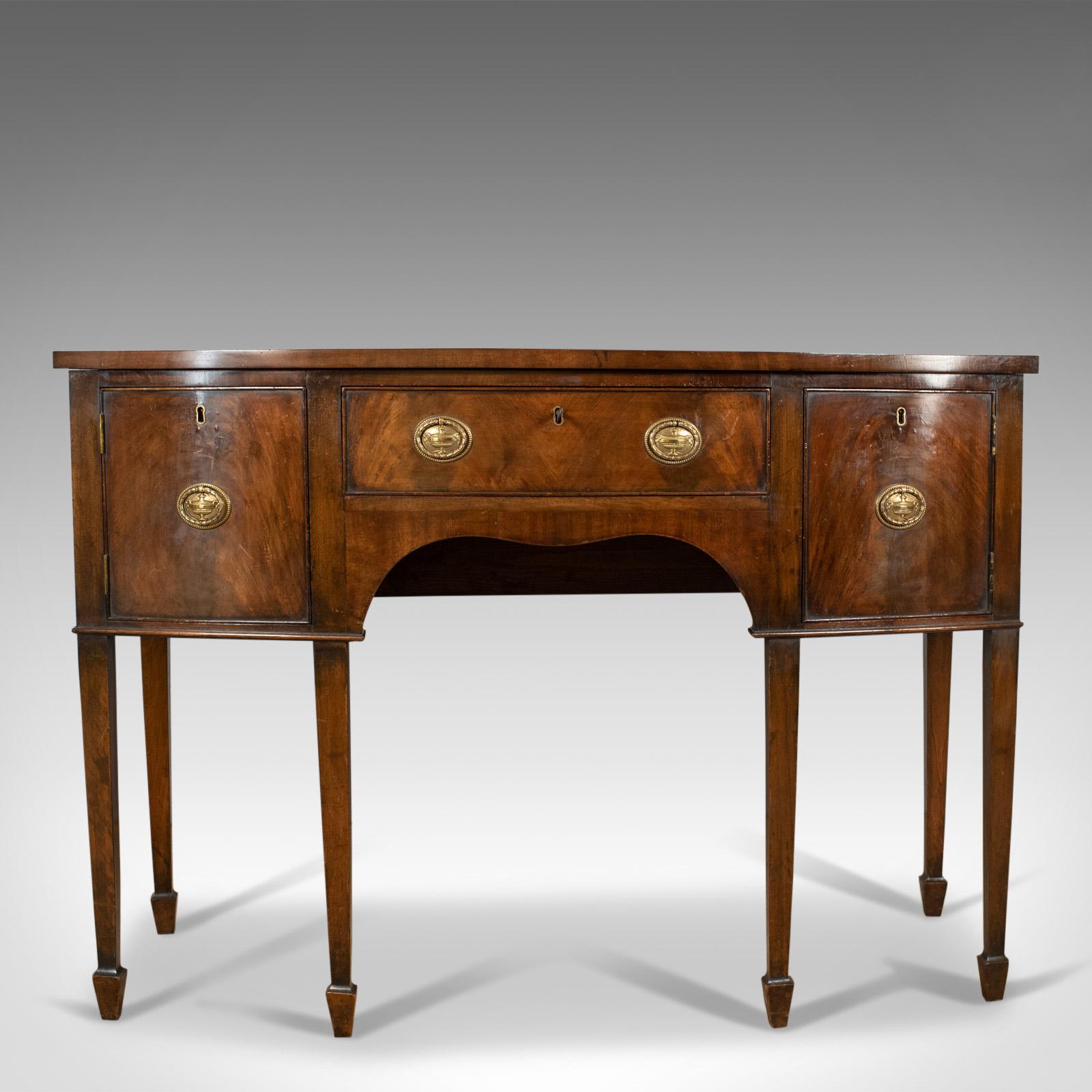 This is an antique sideboard, an English Regency revival server in mahogany dating to the late 19th century, circa 1890.

Select mahogany with grain interest throughout
Desirable aged patina in the lustrous, wax polished finish
Displaying
