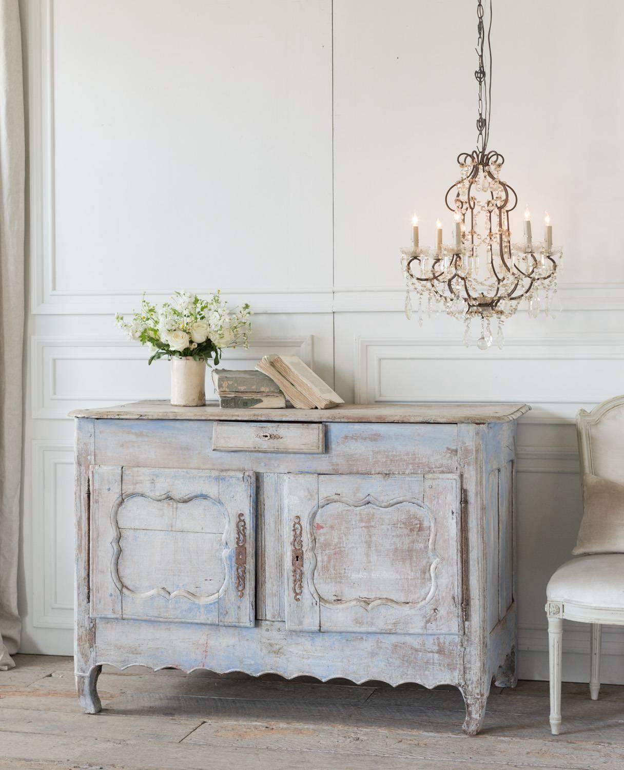 This sweet, two cupboard sideboard is washed in a powder blue and adds the perfect touch of farmhouse to any room. A cherubic little drawer, scalloped carvings, and original hardware set this piece apart from any others. Although the accompanying