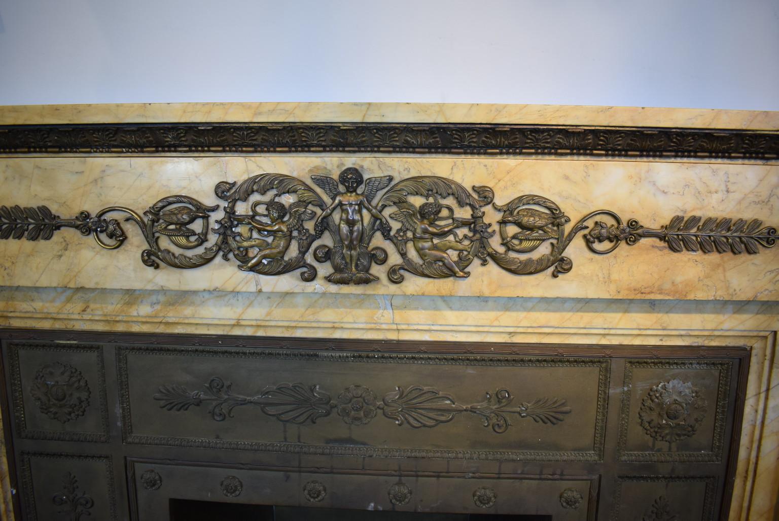 Unique French Empire style Siena marble mantel with gilt bronze ormolu and original bronze surround.