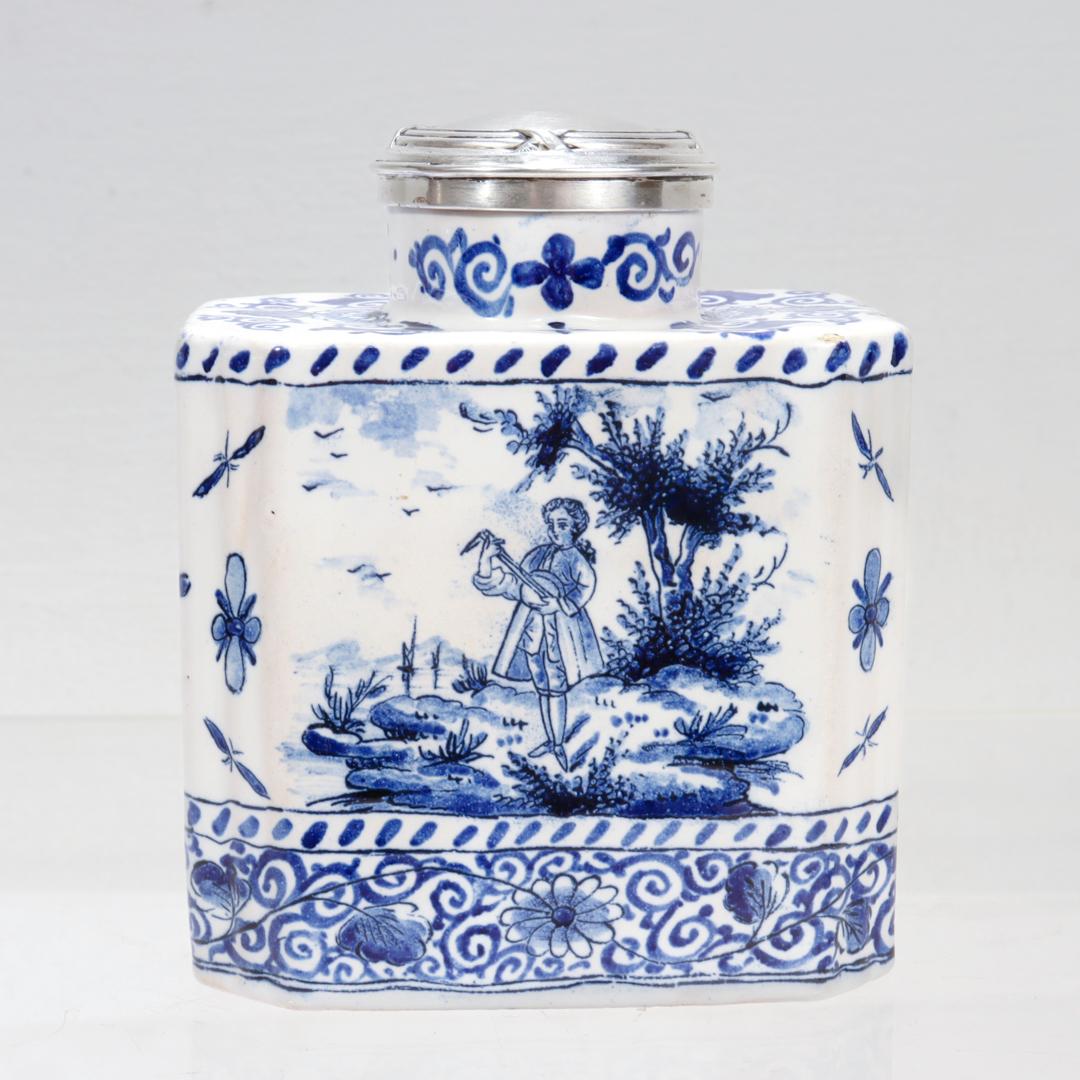 A fine antique Dutch tea caddy.

In tin glazed blue and white Delft pottery.

Decorated in the 18th Century style with depictions of a lute playing gallant to one side and a lady to the other. The remaining sections are decorated with floral sprays,