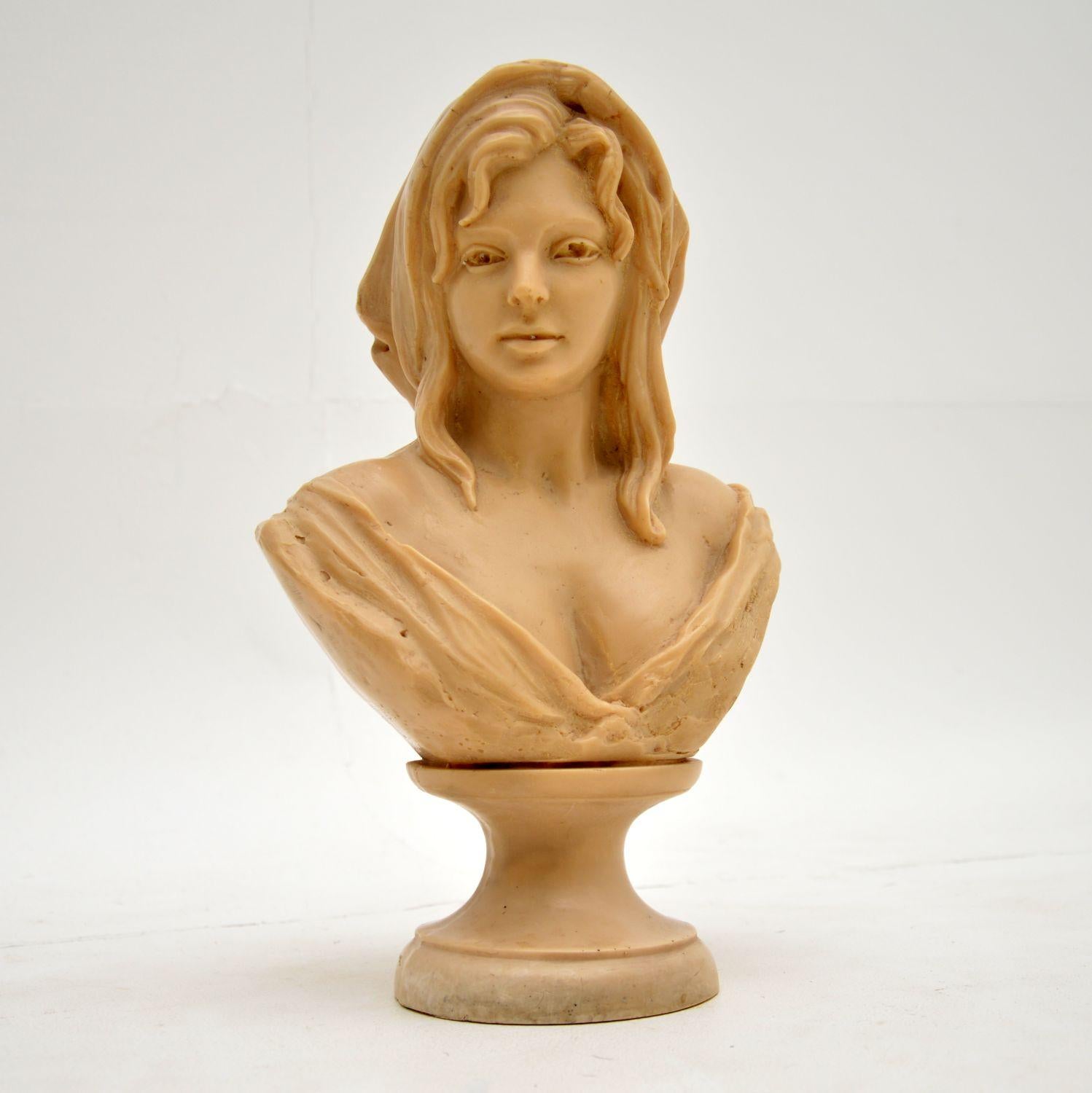 A beautiful artist signed bust of a woman, this is made from some sort of composite, possibly resin. It’s hard to date, but has some age and I would estimate around the early twentieth century possibly 1930-50’s.

It is beautifully made, is a nice