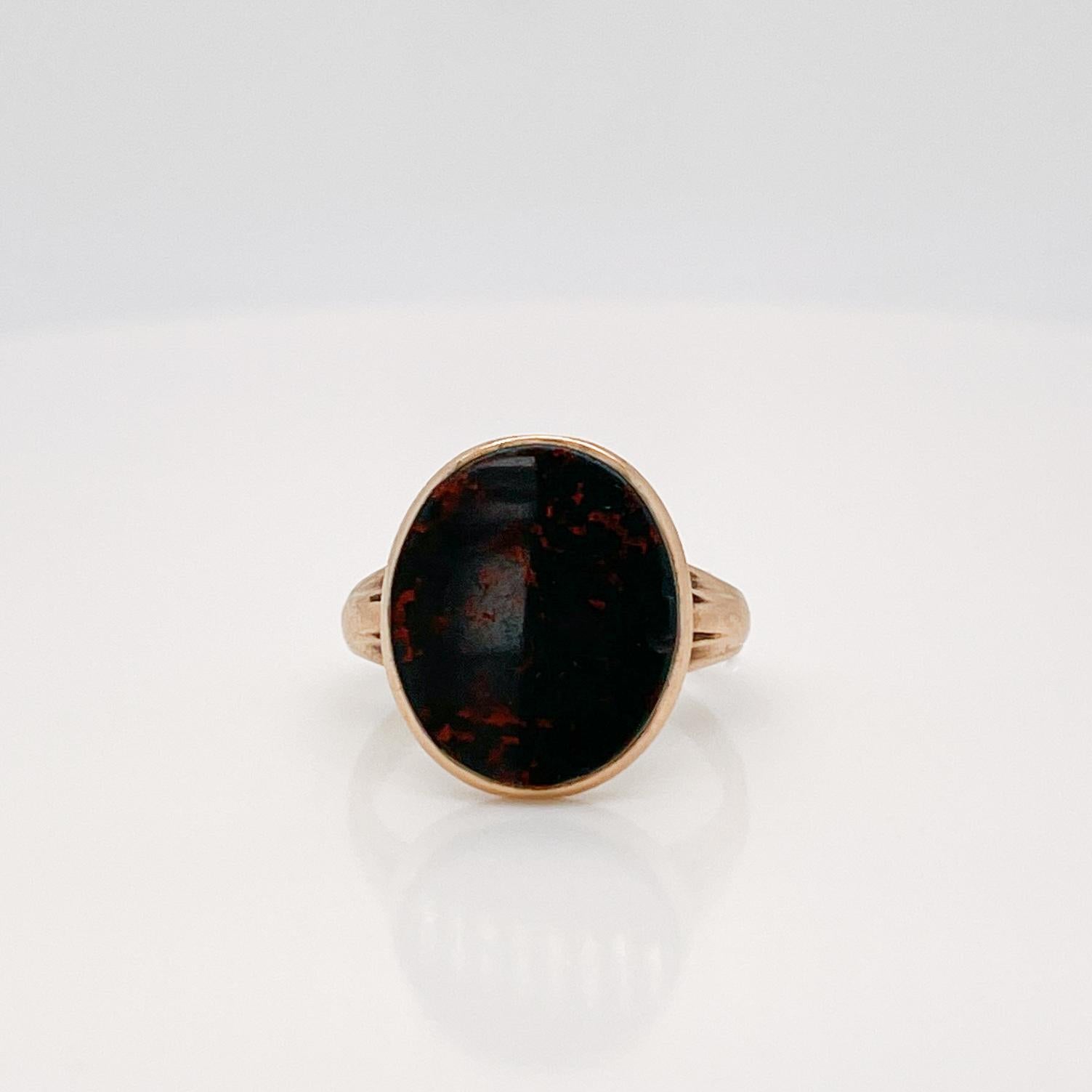 A very fine antique Edwardian 14k gold and bloodstone ring.

With a smooth oval bloodstone bezel set in 14k gold signet style setting.

Made by George Street & Sons Jewelry Co. of New York, New York.

Simply a wonderful signed ring!

Date:
Late 19th