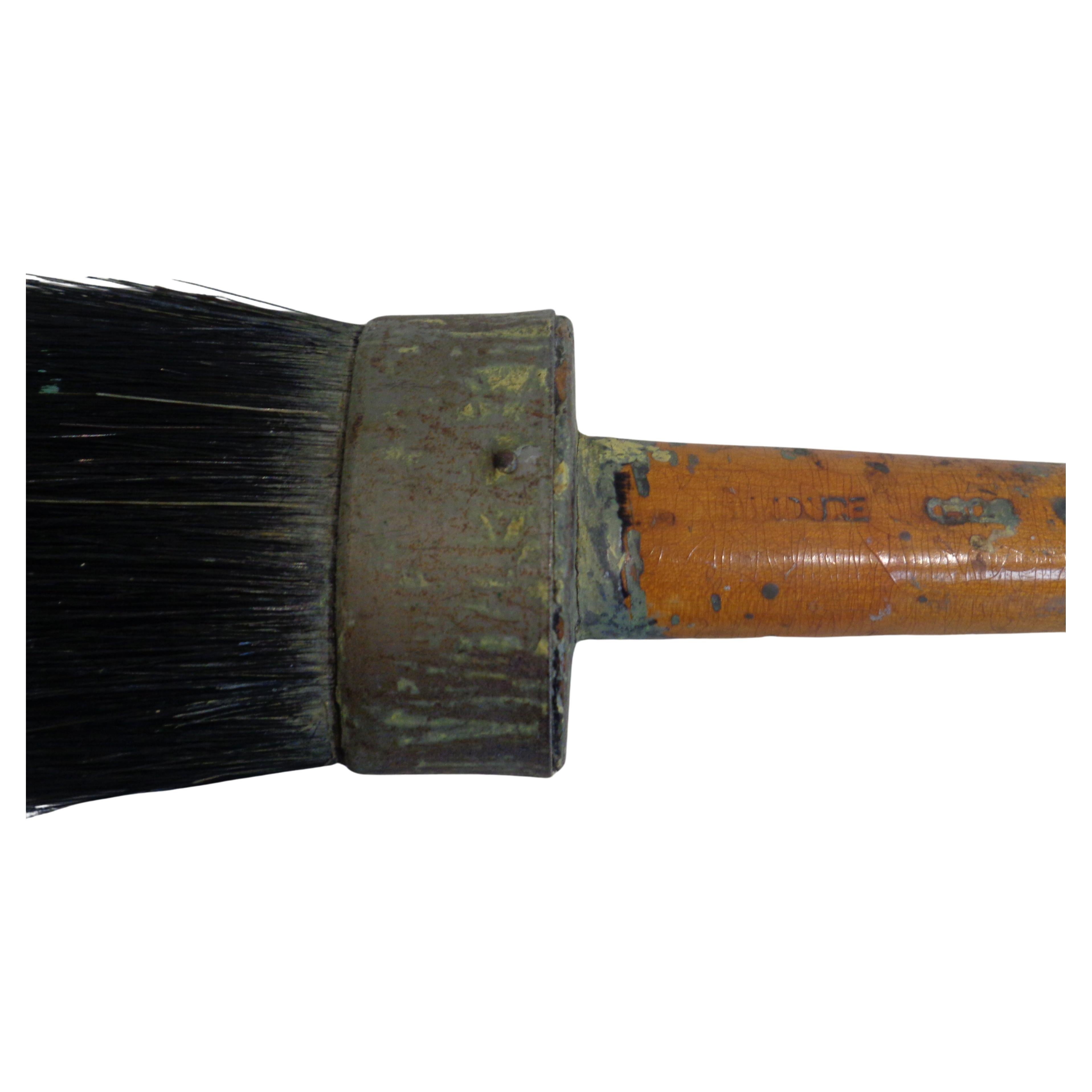 A large antique artist paint brush - perfectly aged rounded oval shaped wood handle w/ large horsehair bristles encased in riveted metal. Incise signed on handle but cannot decipher. Likely French in origin. Beautiful old brush. Look at all pictures