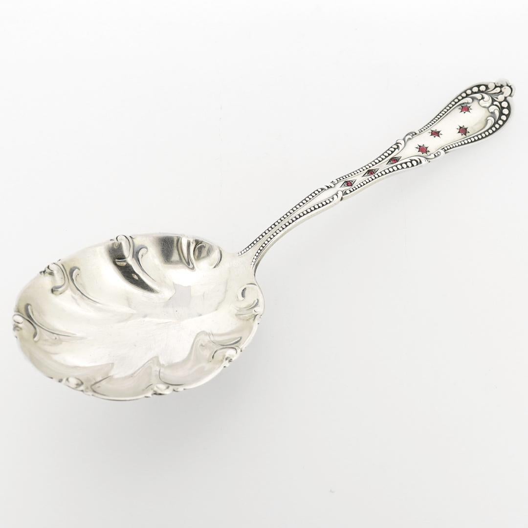 A fine antique sterling silver serving spoon.

In sterling silver.

By Campbell-Metcalf.

Pattern: Colonial

Set to the handle with glass cabochons in star and diamond bezels.

Simply a wonderful 'bejeweled' serving spoon!

Date:
20th