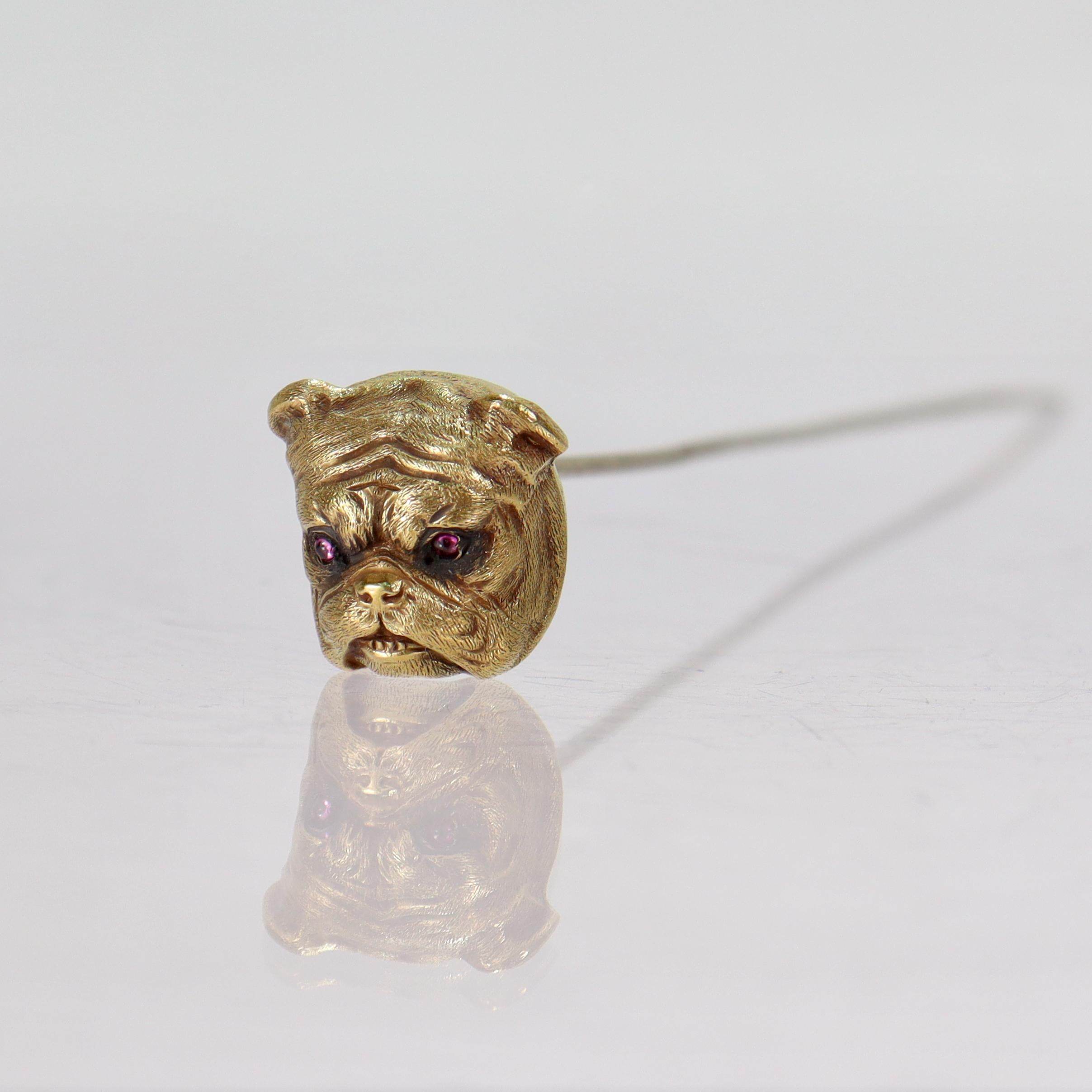 A fine antique 14k gold & ruby hatpin.

By Sloan & Co.

With a figural bulldog top set tiny ruby cabochon eyes.

The pin stem is gold plated.

Simply a great pin for any bulldog lover!

Date:
20th Century

Overall Condition:
It is in overall good,