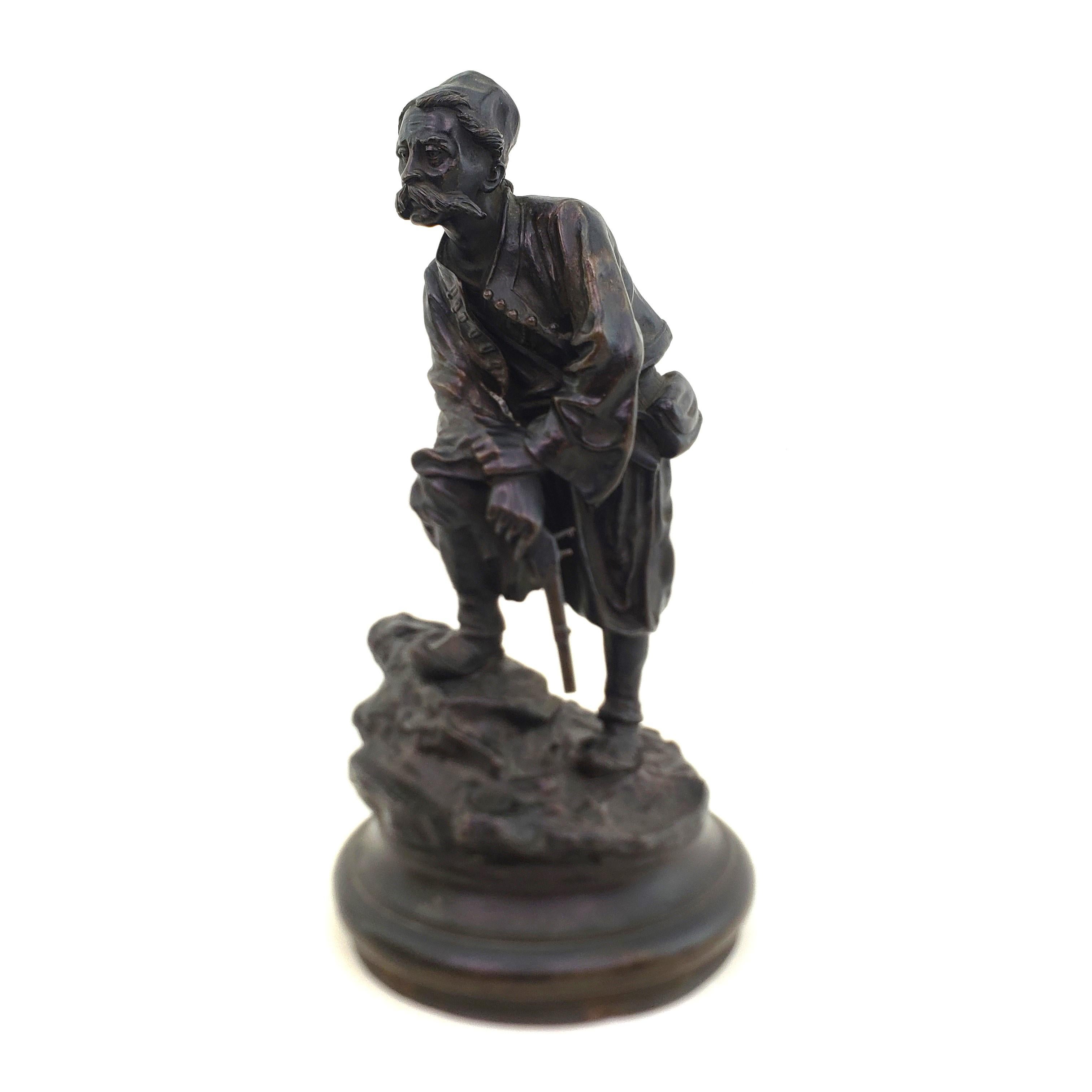This antique sculpture was done by the well known Vasily Grachev of Russia and dates to approximately 1880 and done in his signature style. The sculpture is done in a very ornately cast and patinated bronze with a turned wooden base. The sculpture