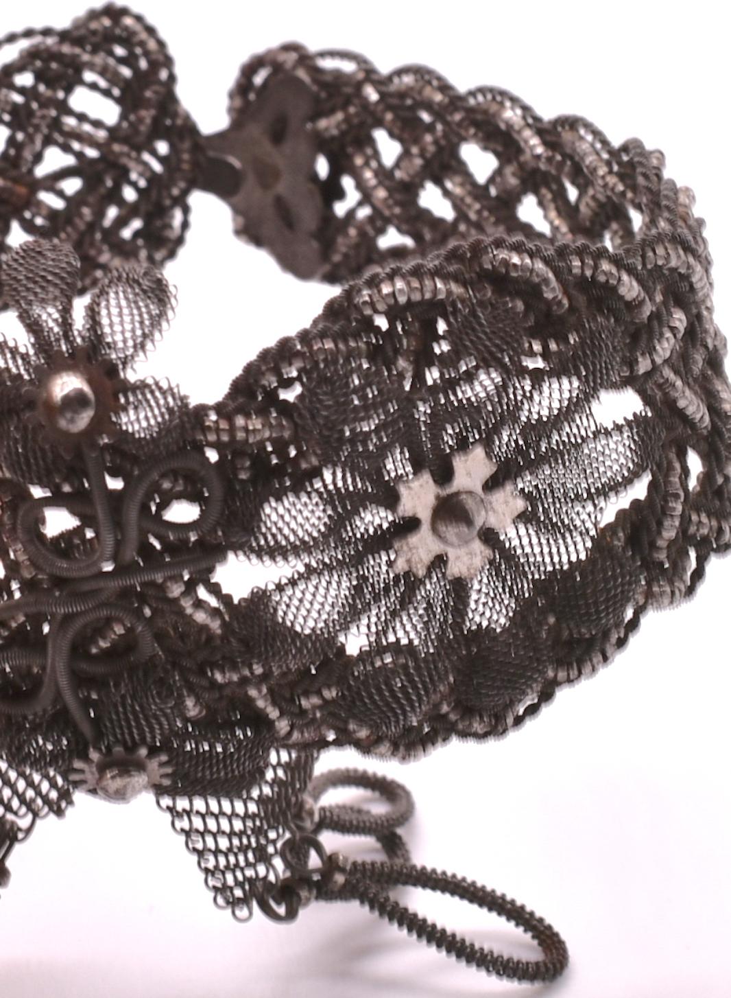 Silesian wire was originally made in the medieval town of Gleiwitz in Silesia and was thought to have been made by gunsmiths and armor workers. This Silesian Wirework Braided Cuff Bracelet has intricately layered flowers woven of wire with ties that