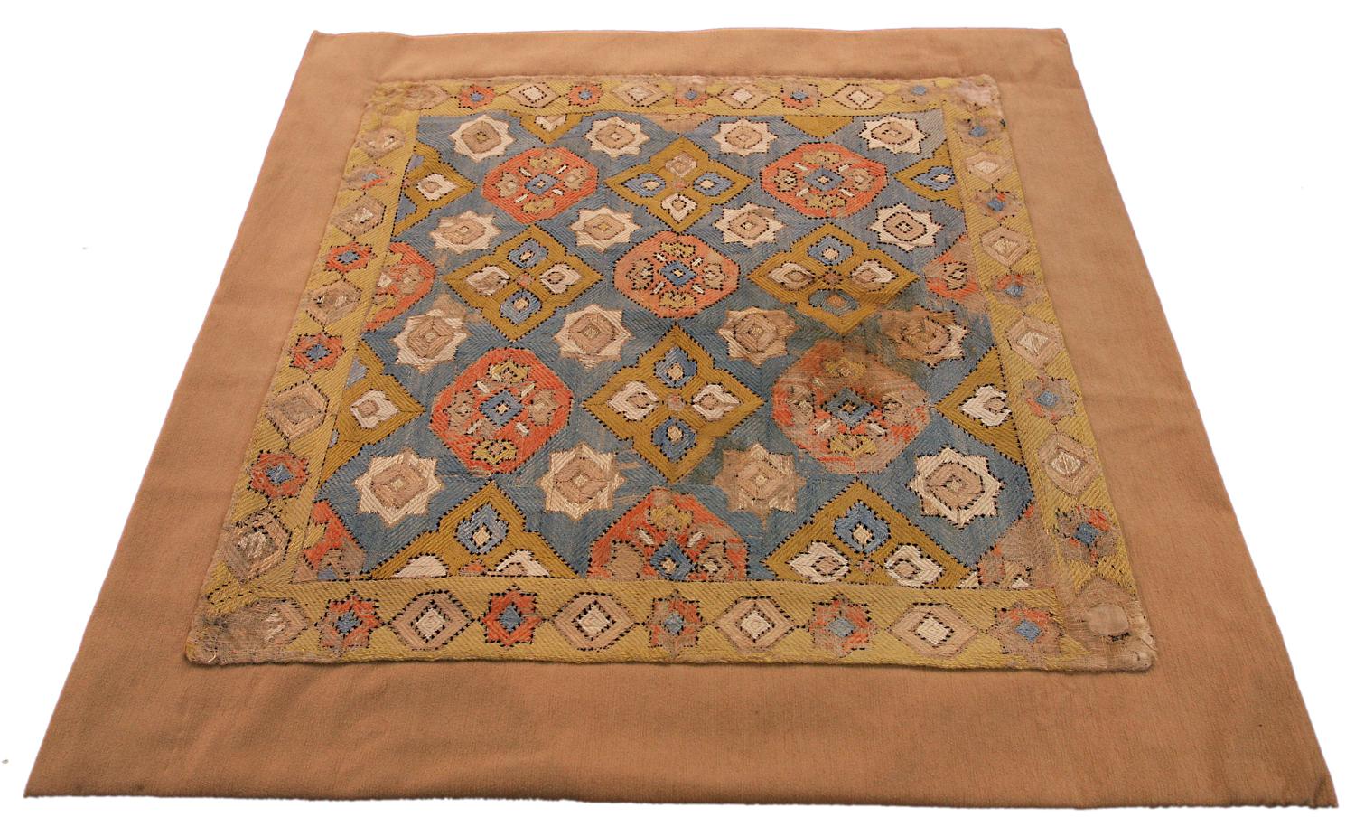 This is an antique silk embroidery woven during the 18th century in Azerbaijan and measures 47 x 47CM in size. This textile has an all-over geometric design with alternating rows of hexagonal and diamond-shaped motifs set on a sky-blue background