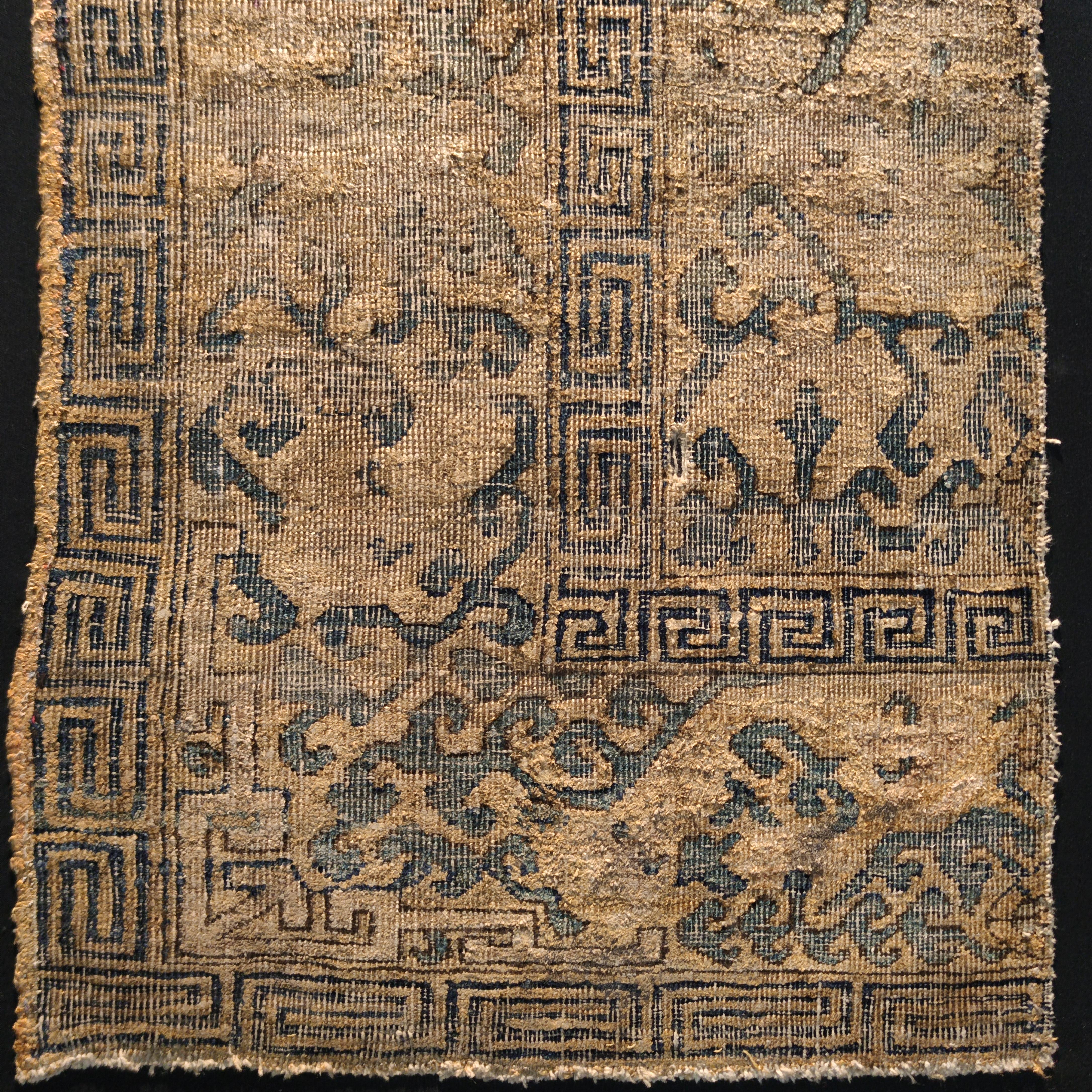 This very rare fragment belongs to a specific group of twelve silk Kashgar throne covers, all with a similar design and palette and distinguished by an extremely fine knotting. Among the group one is in the Victoria & Albert Museum in London and two