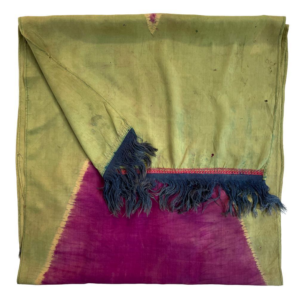 Antique Silk Lawon Ceremonial Shawl, Palembang, Sumatra.
A narrow rectangular silk textile dyed in 2 colors by the  tritik (stitched and gathered resist) process having a crisp delineation of a magenta diamond on an apple green ground. The ends with