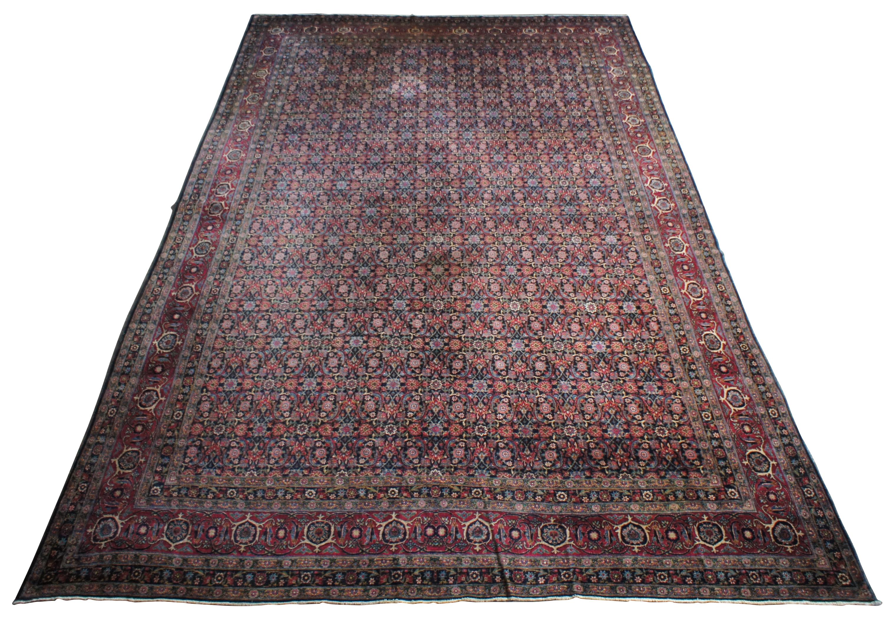 Antique silk and wool tabriz rug or carpet. Features a field of reds and blues, patterned flowers and floral motif, and a triple boarder. Approx 225 knots per square inch. Rug came from a German estate and was appraised in the late 20th century