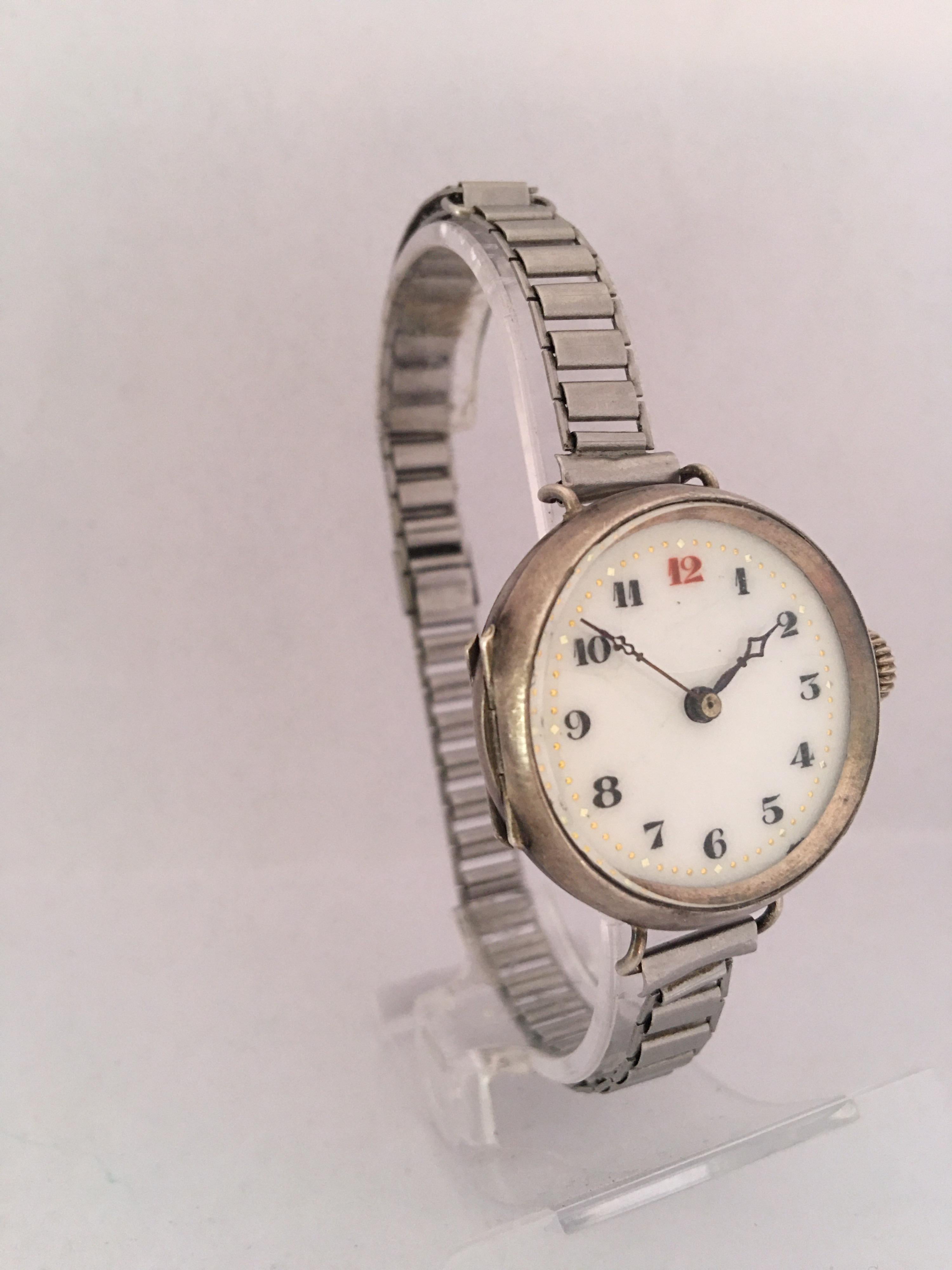 This beautiful antique hand winding silver pin set ladies trench watch is in good working condition and it is ticking well. Visible signs of ageing and wear with light marks on the glass and on the watch case as shown. A few hairline cracks across