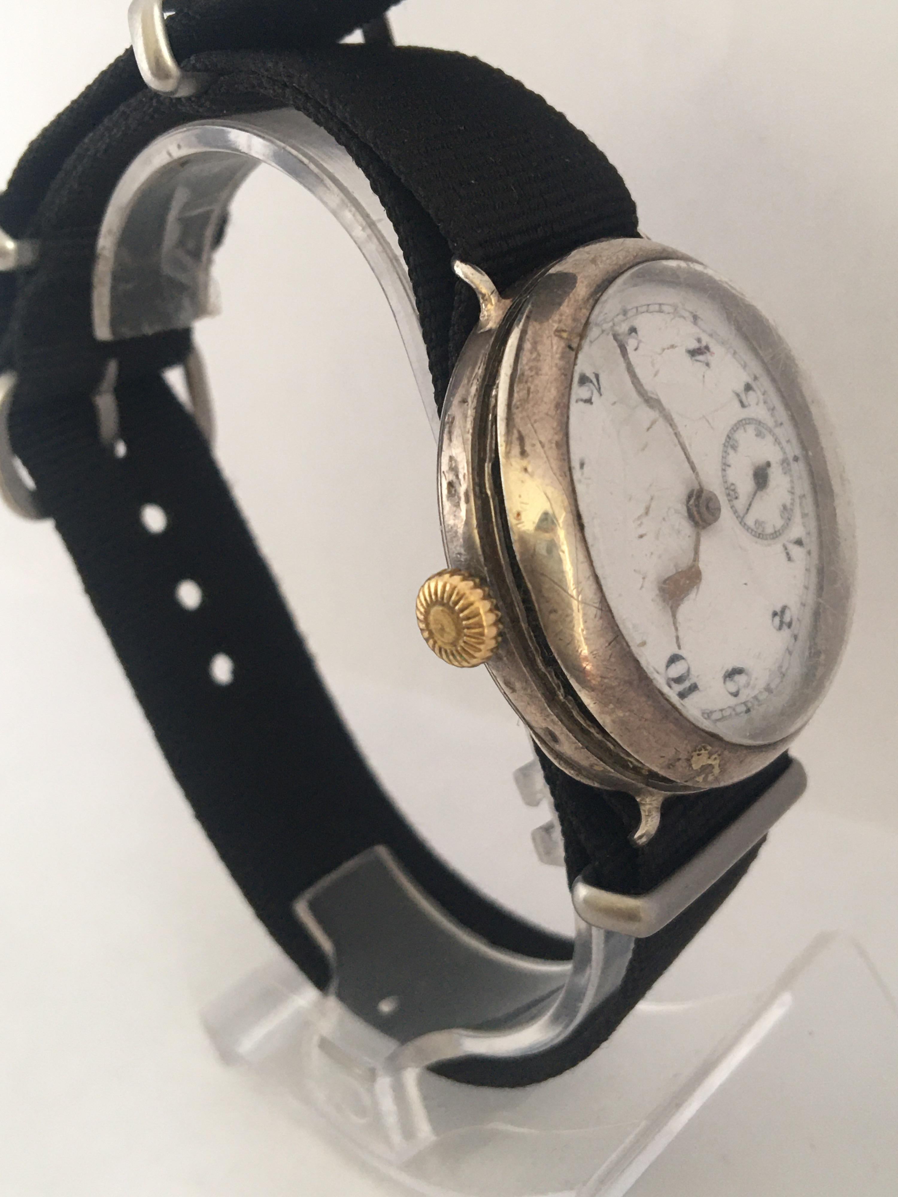This beautiful hand-winding Antique Trench Watch is working and it is ticking well. Visible signs of ageing and wear with fine scratches and dents on the silver watch case and on the glass. some fine cracks on the enamel dial and the front watch