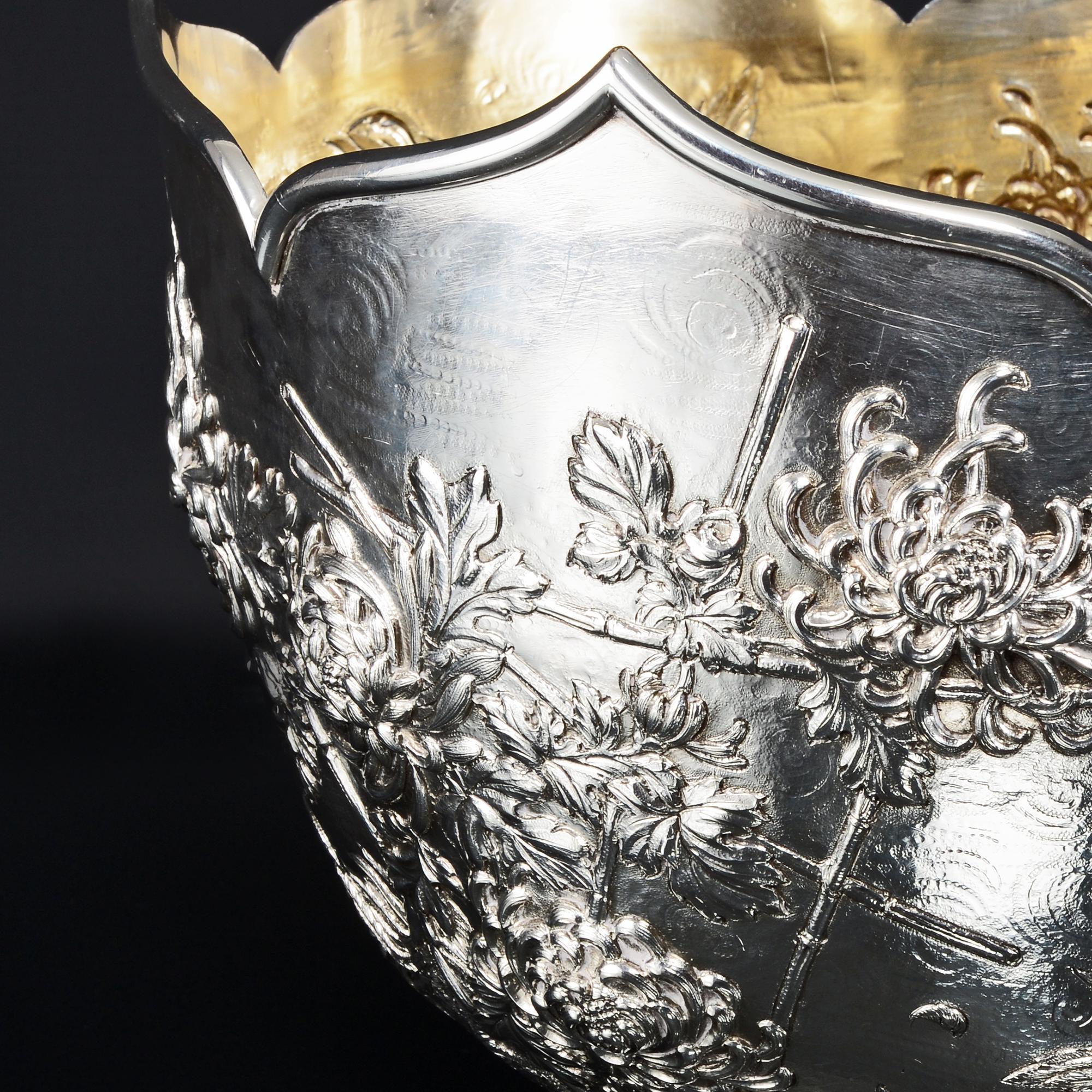 This amazing antique Edwardian sterling silver bowl is entirely handmade and styled after a Chinese design. The reliefs of chrysanthemums and fighting cocks are exceptional, being hand-chased with incredibly fine detail, even including loose