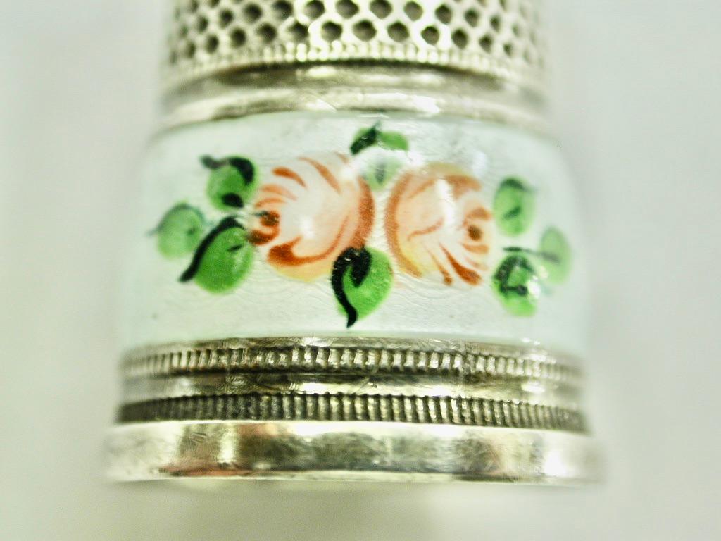Antique Silver and Enamel Thimble with Dimpled Ruby Glass Top Circa 1920
Made in Germany of 935 standard silver.
Lovely flower decoration on the enamel with a gilt interior.