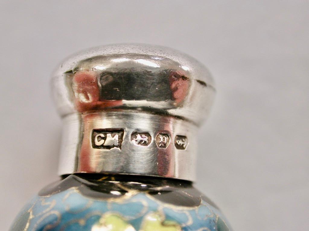 Antique Silver And Hand Painted Porcelain Scent Bottle 1889 Birmingham, maker Charles May
This unique scent bottle was hand painted to give an appearance of being made as Cloisonne
enamel.
The lid has an inner thread with a cork lining to keep the