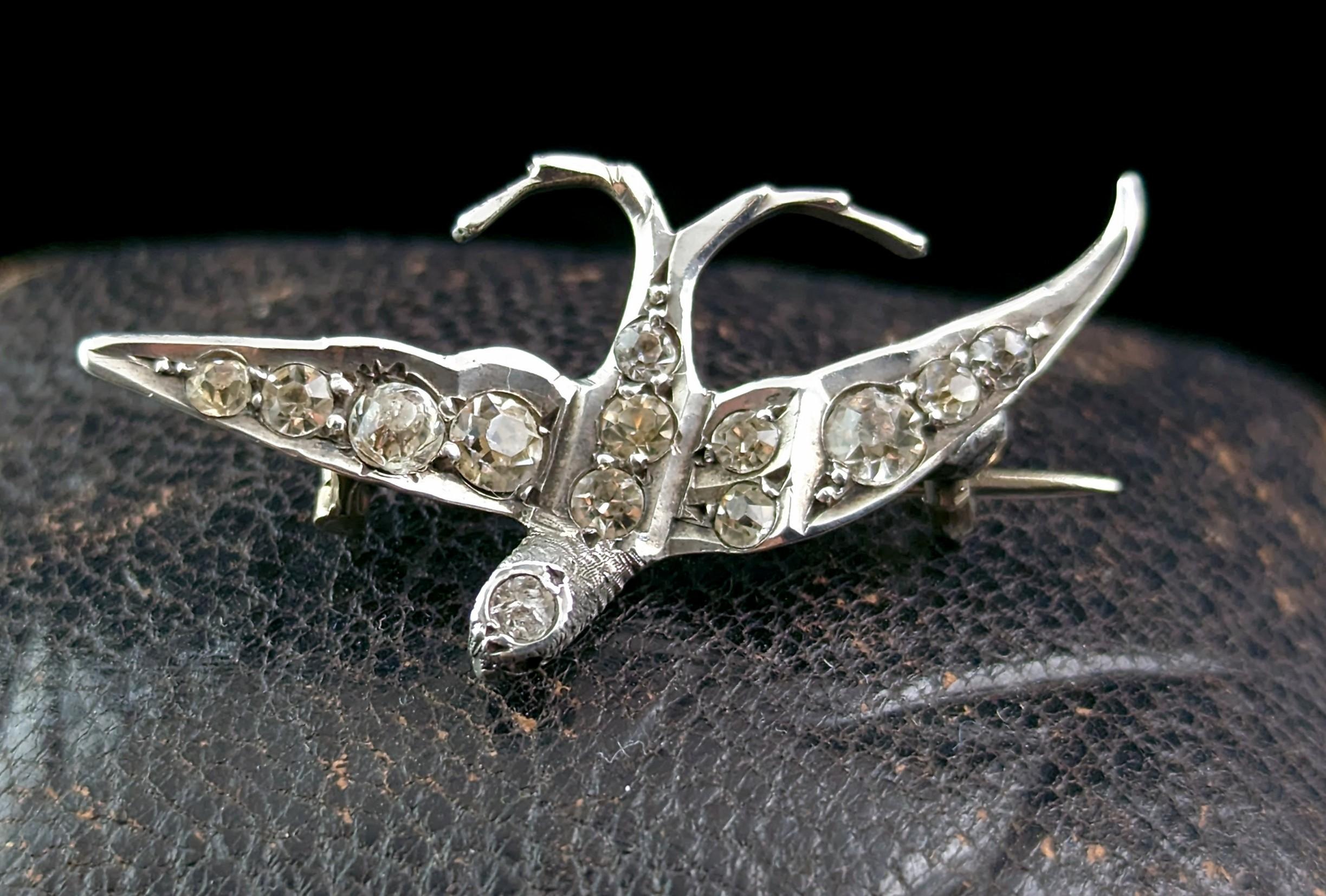 A sweet antique Victorian era sterling silver and paste swallow brooch.

The brooch is made from cool silver and is adorned all over with twinkling clear paste stones with a ruby coloured paste eye.

The swallow was steeped in symbolism in the