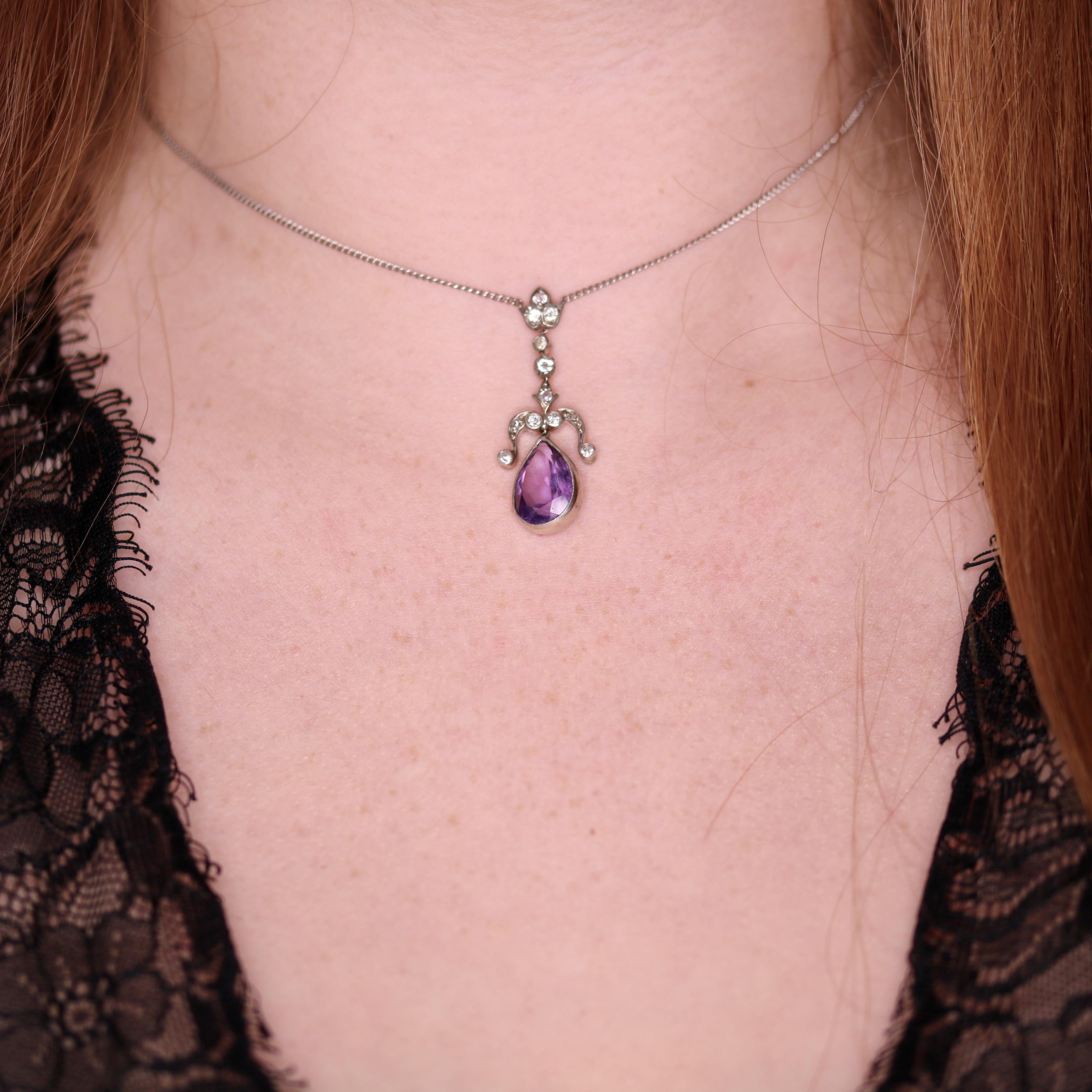 An antique necklace in silver, gold and platinum, comprising of one large pear cut amethyst and 12 old cut diamonds, set in silver, backed in gold, on a fine curb link chain of platinum. 

The principle pear cut amethyst is a lovely lilac colour and