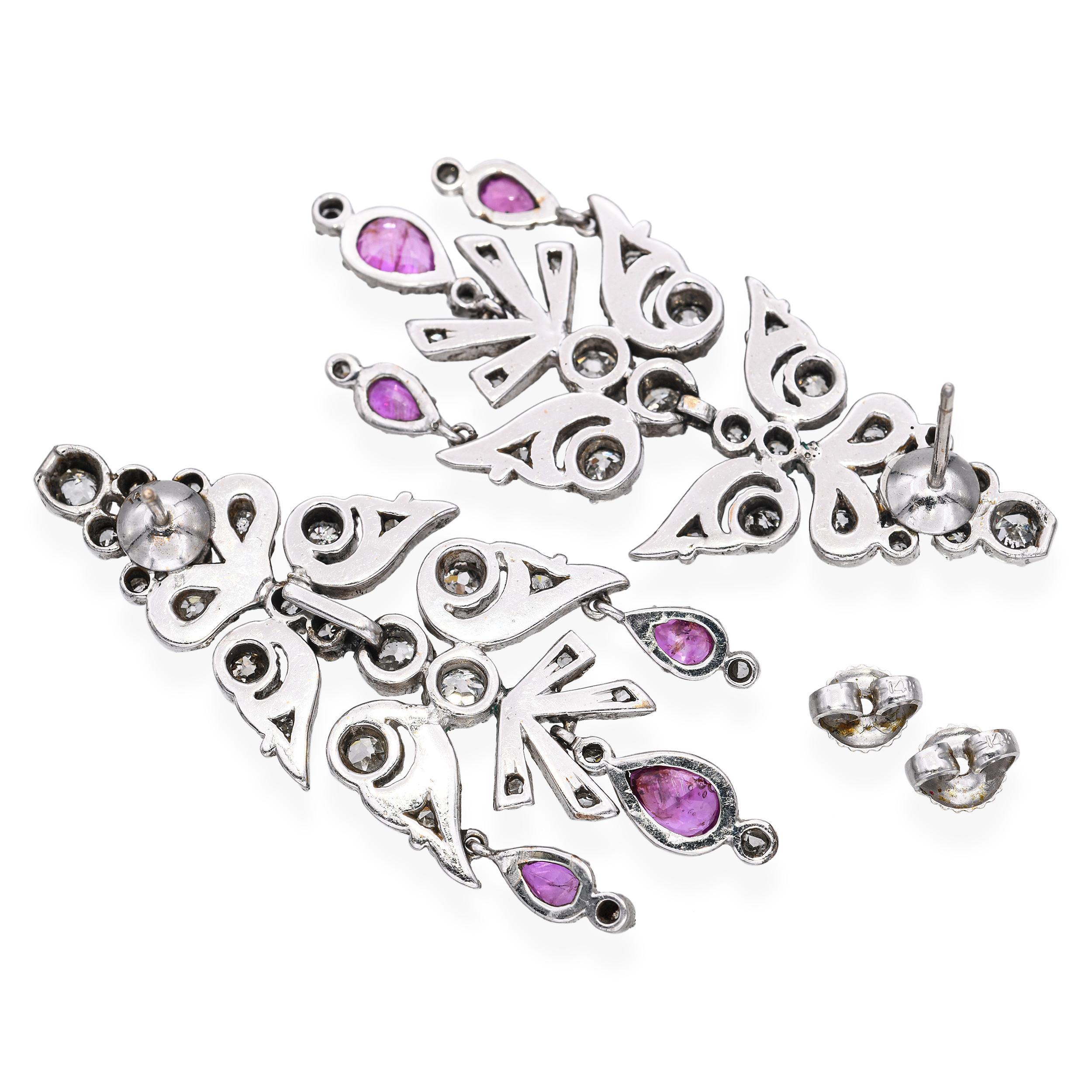 These exquisite antique earrings are crafted in white gold back and adorned with 2.52 carats of sparkling diamonds paired with 1.5 carats of pink sapphires all set in silver. The intricate design reflects fine early craftsmanship, combining delicate