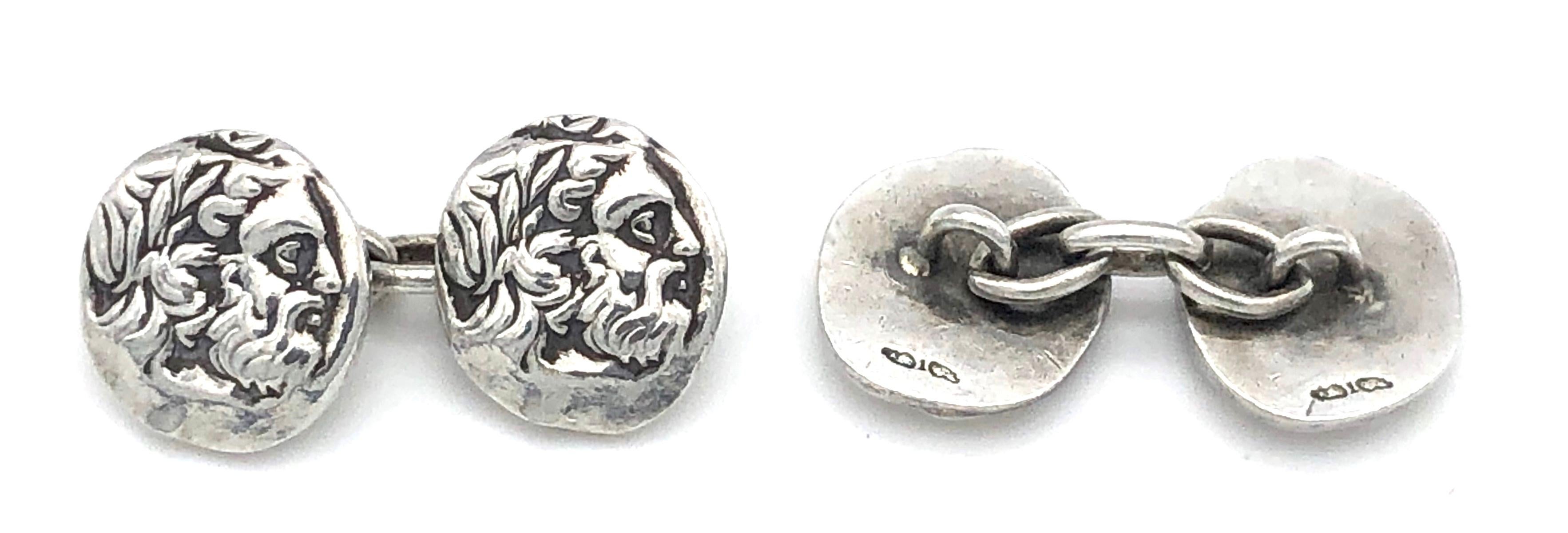 Casts of silver coins from antiquity depicting the profile of a bearded dignitary wearing a laurel wreath have been made into a pair of unusual cufflinks.