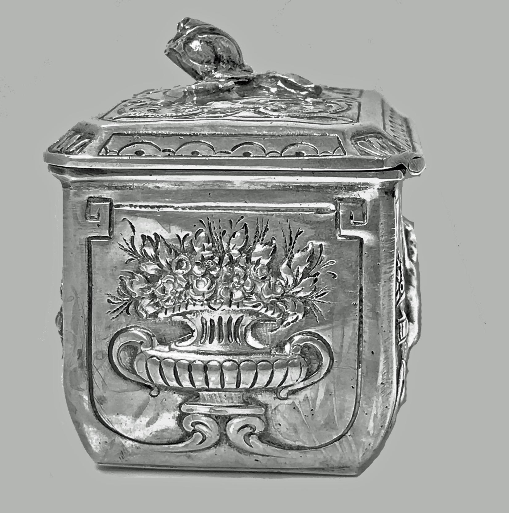 Antique Silver Box, Germany C.1890 The box in the form of a small casket, all with embossed raised decorative depictions of winged angels cupids, foliage and classical urns against, the hinged cover with an applied raised foliage closed petal