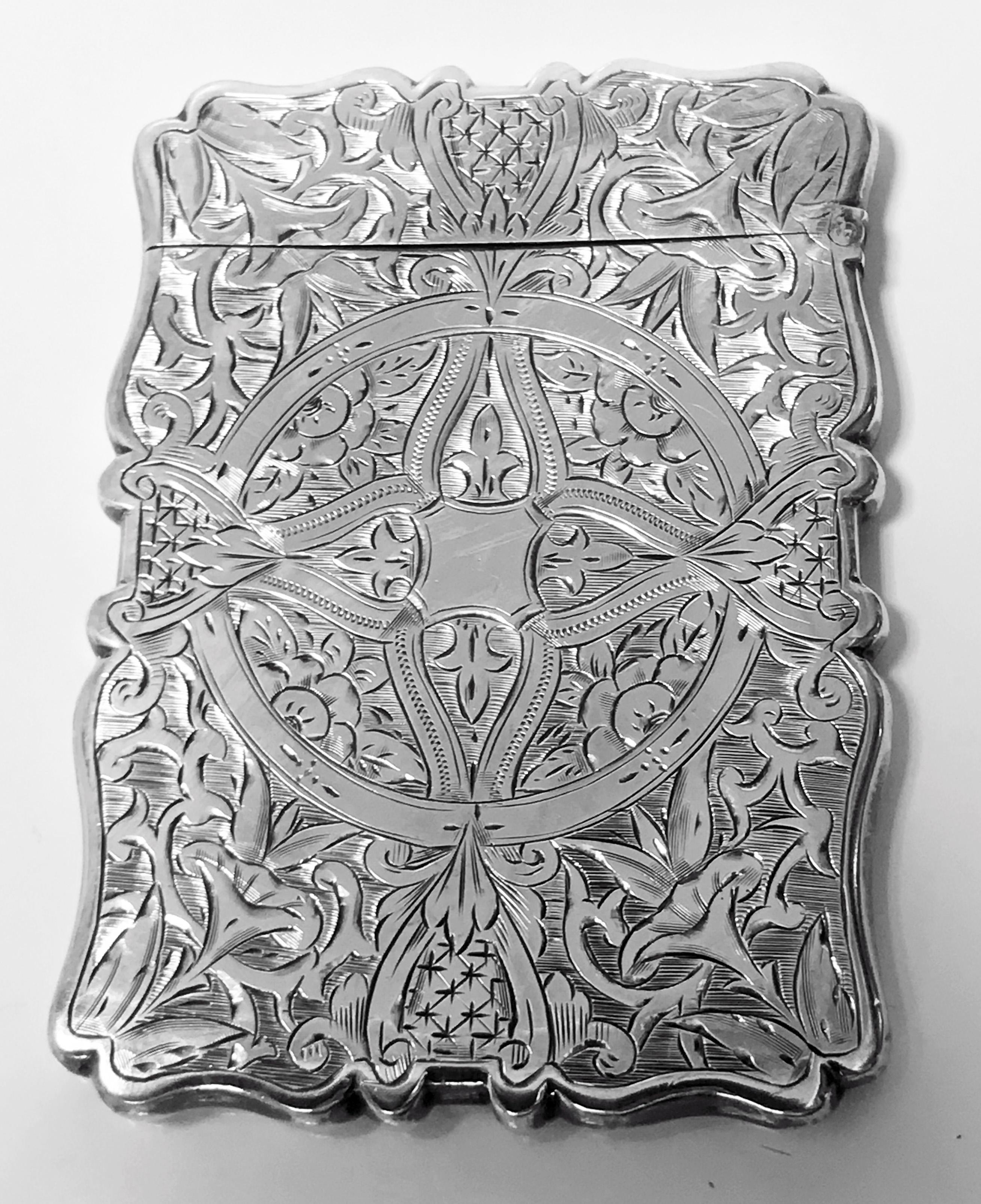 Antique silver card case, Birmingham 1869 Frederick Marson. The card case rectangular form richly engraved foliate diaper and pin pricked decoration, hinged cover. Measures: 9.50 x 7.00 cm. Total item weight: 54.88 grams.